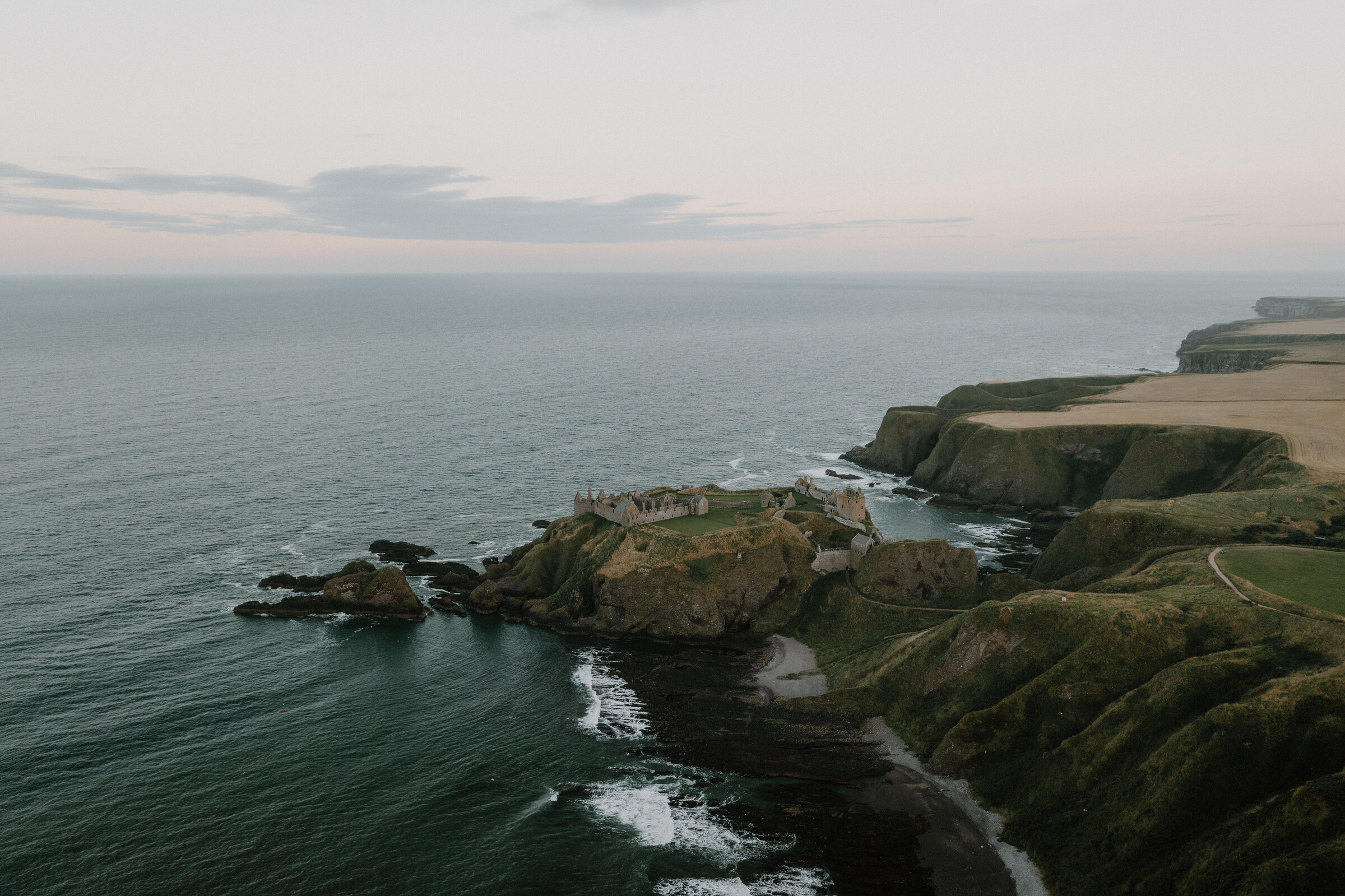 Dunnottar Castle on its headland south of Stonehaven, in soft evening light.