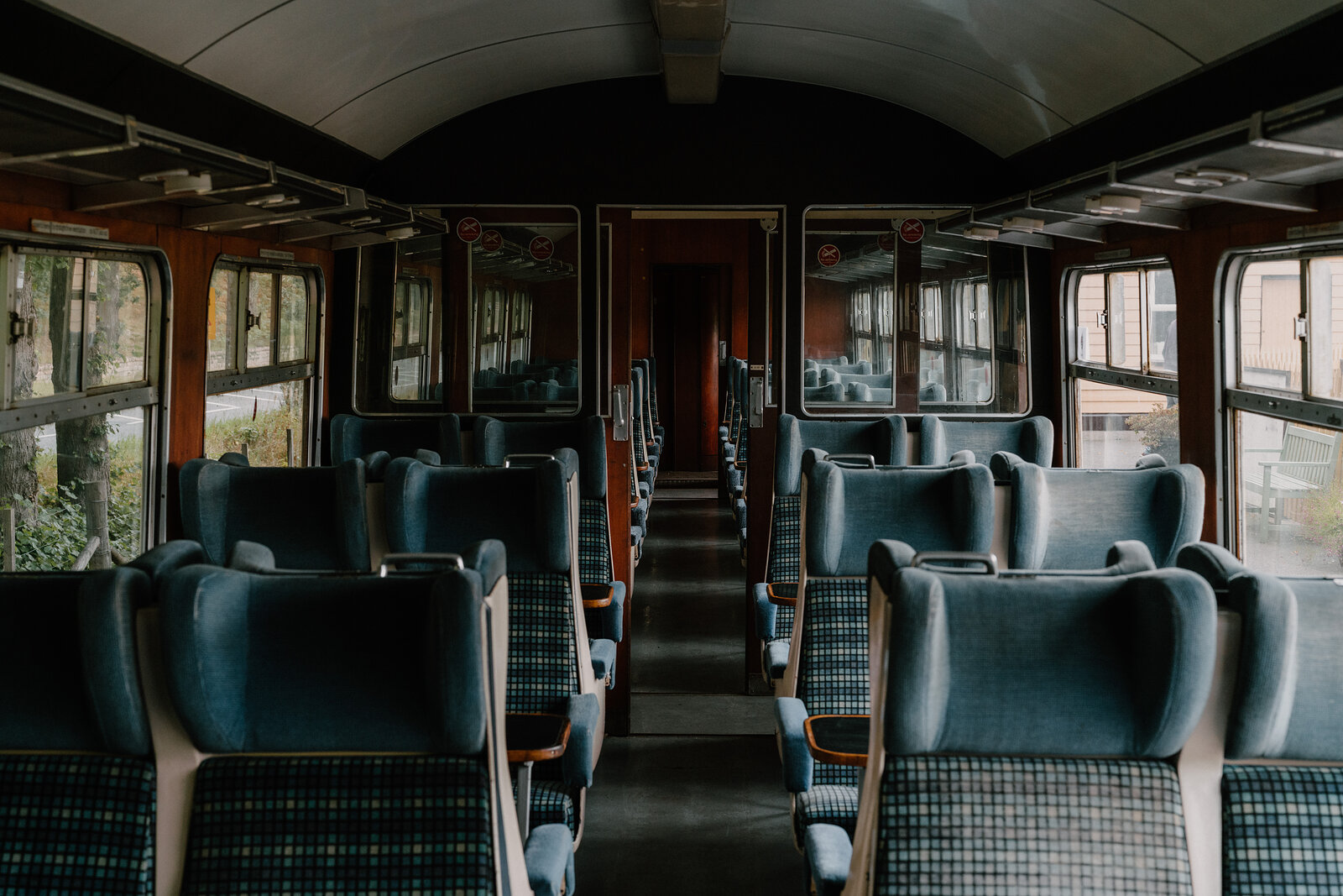 Rows of empty upholstered seats inside a vintage railway carriage in Aberdeenshire.
