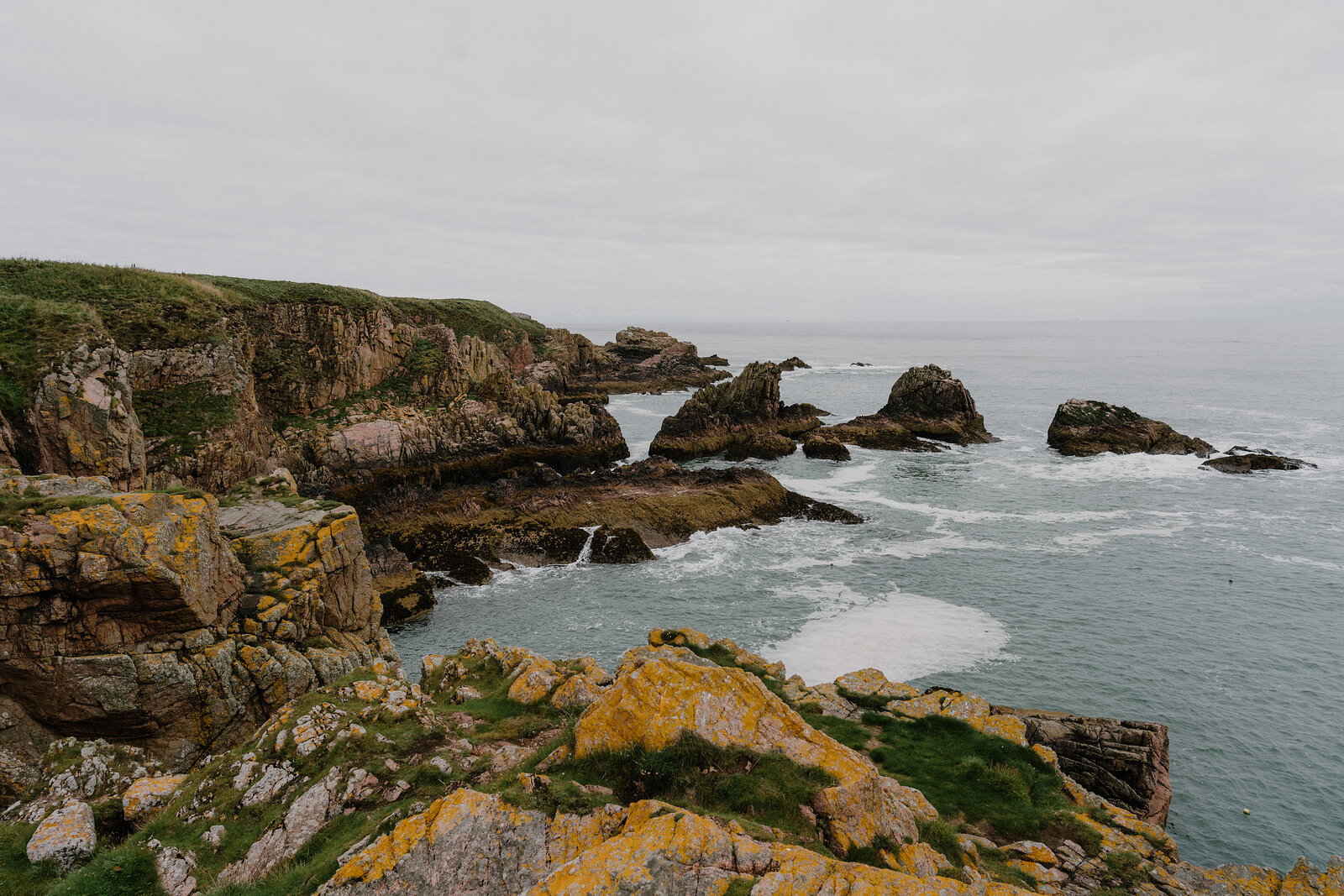 Rugged sea cliffs and rock stacks along the Aberdeenshire coast.