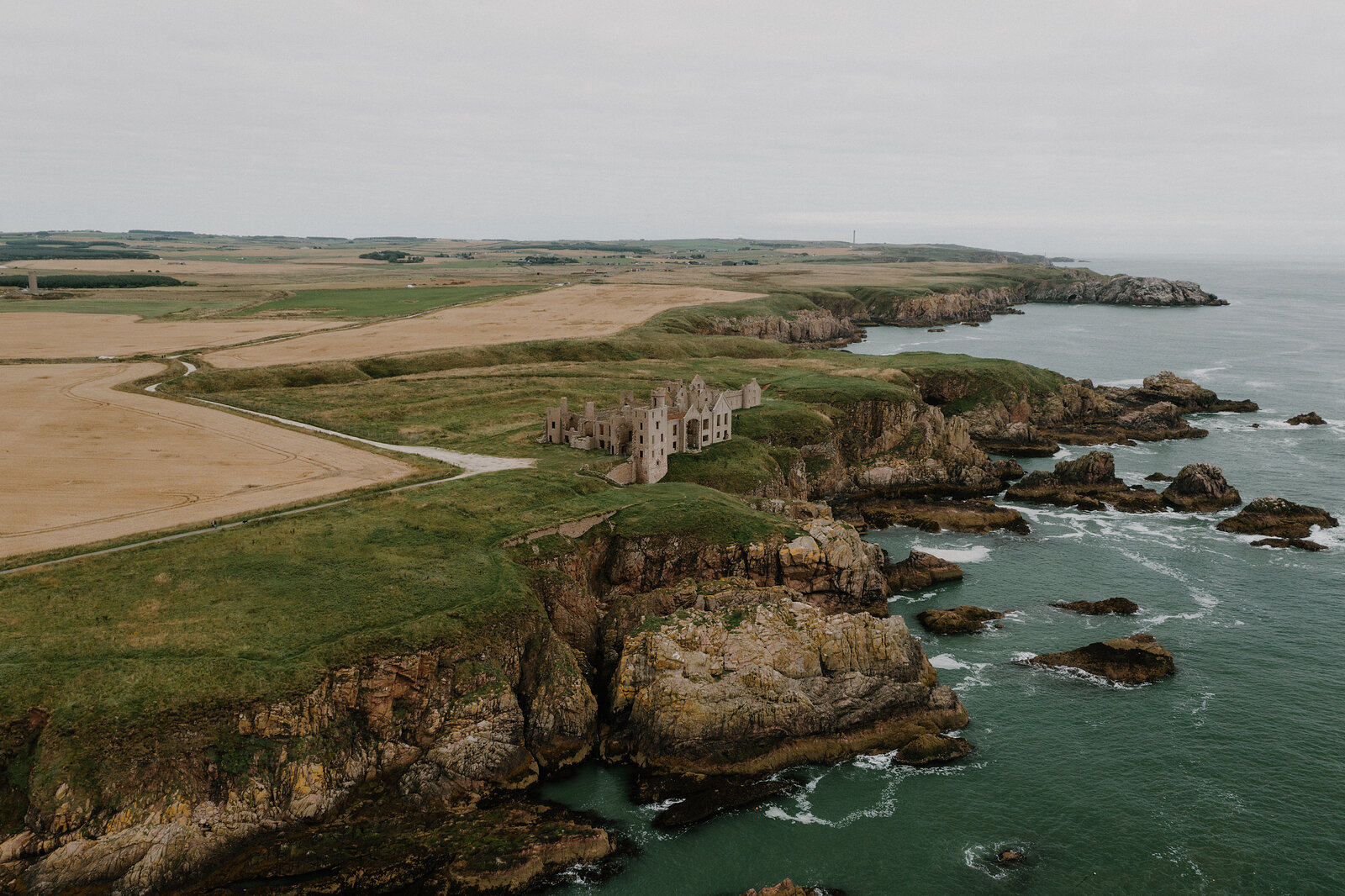 A ruined castle standing on a clifftop above the sea in Aberdeenshire.