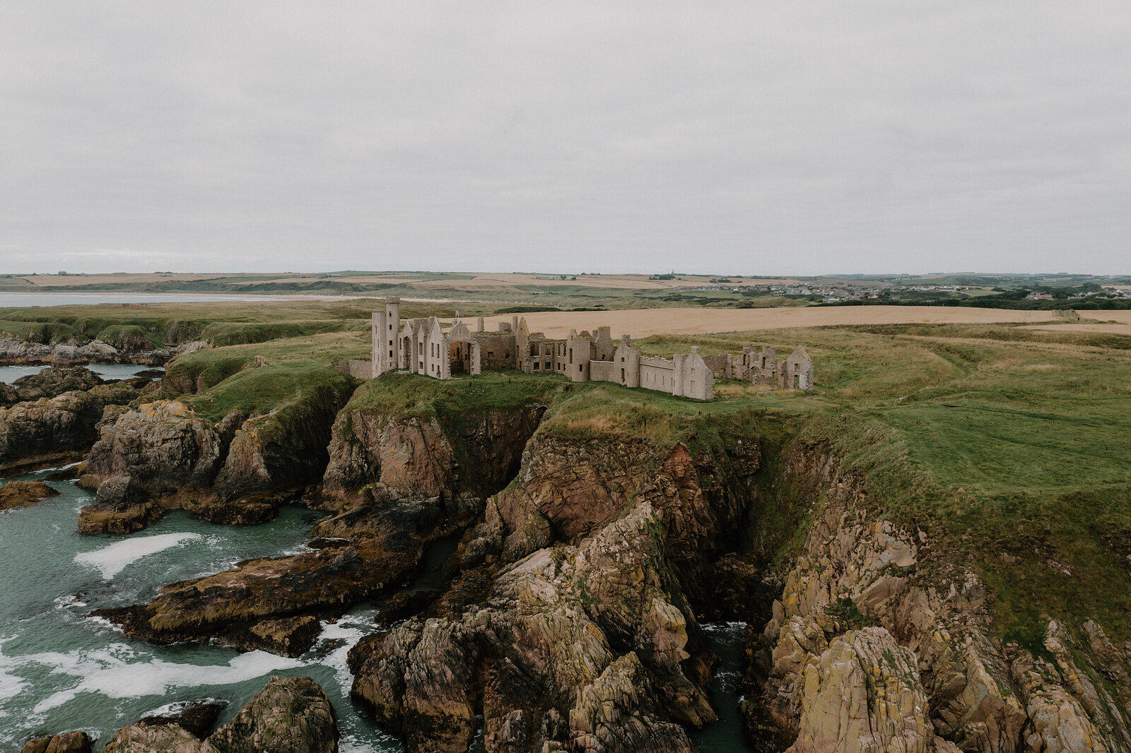 A ruined castle standing on a clifftop above the sea in Aberdeenshire.