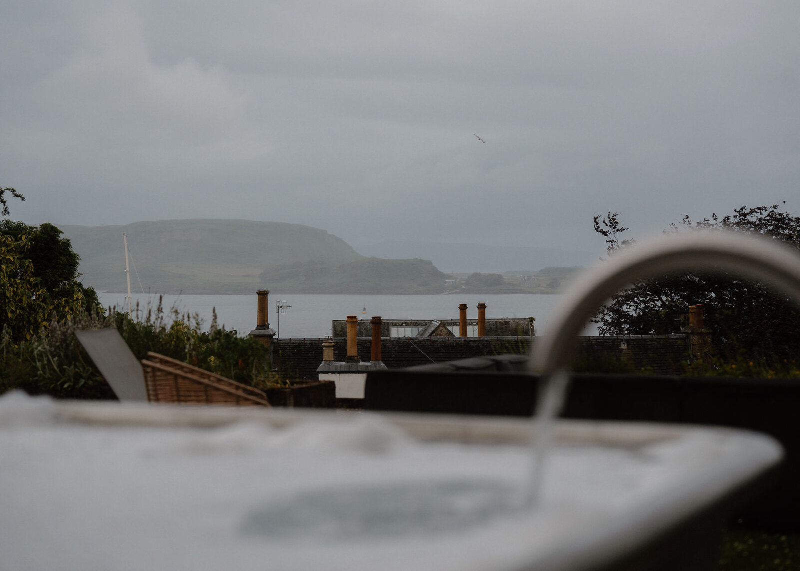 A landscape view from the spa bath over the town's chimney pots to Kerrera and the Sound.