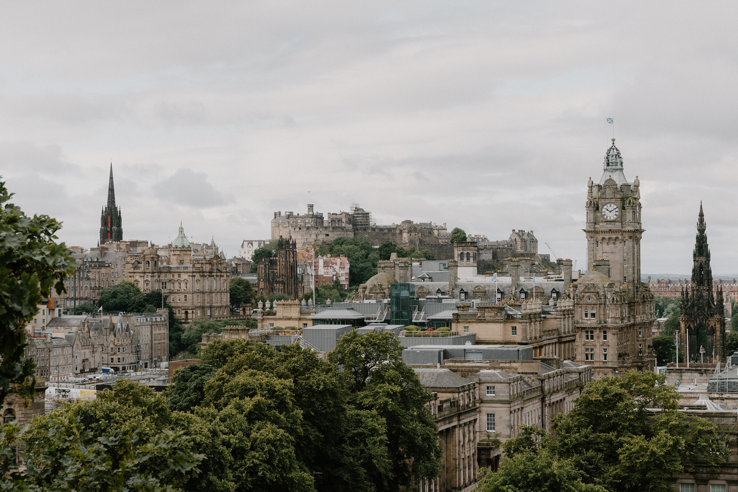 The castle and the Balmoral clock tower over the rooftops, from Calton Hill.