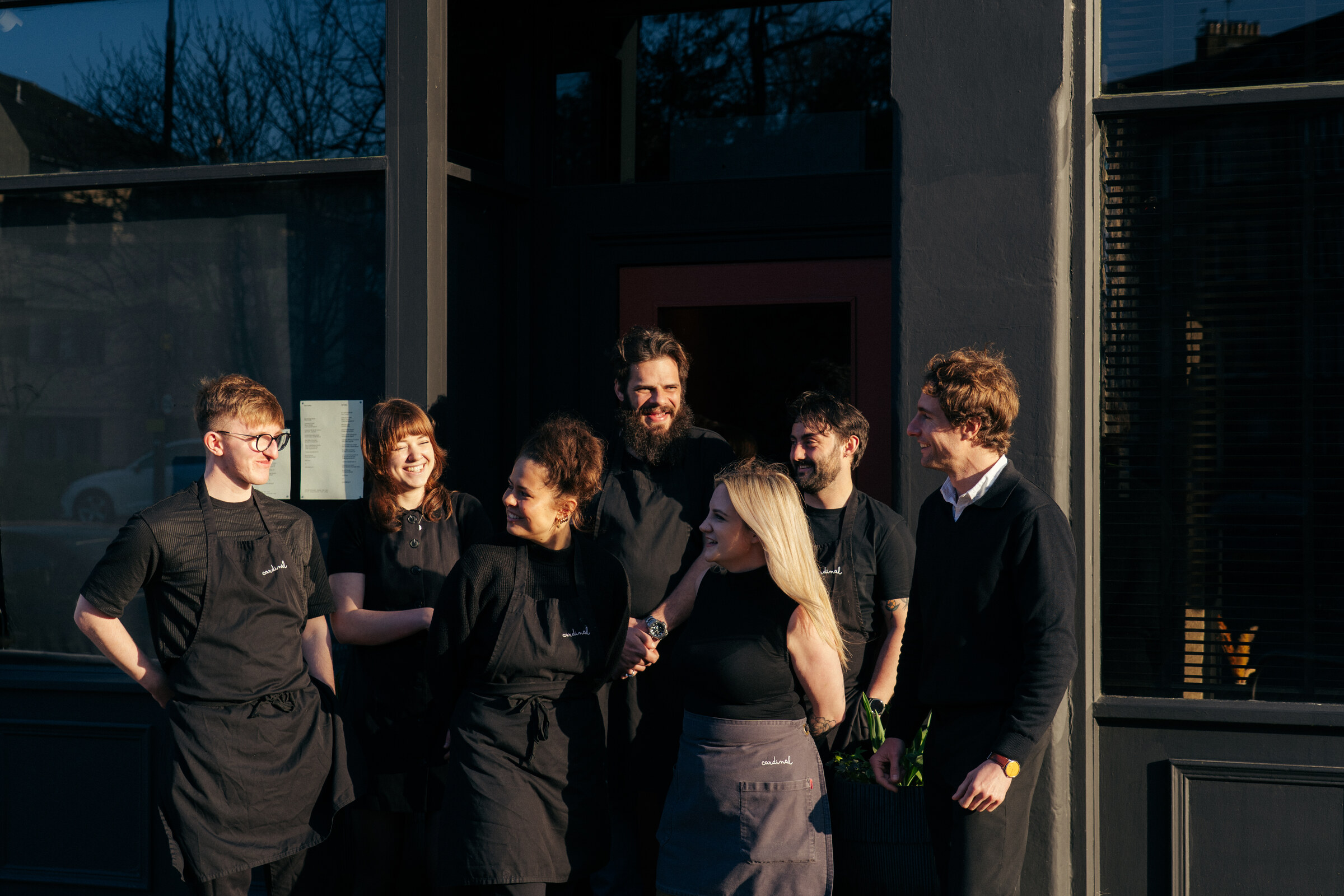 The Cardinal team together outside the restaurant in the evening sun.