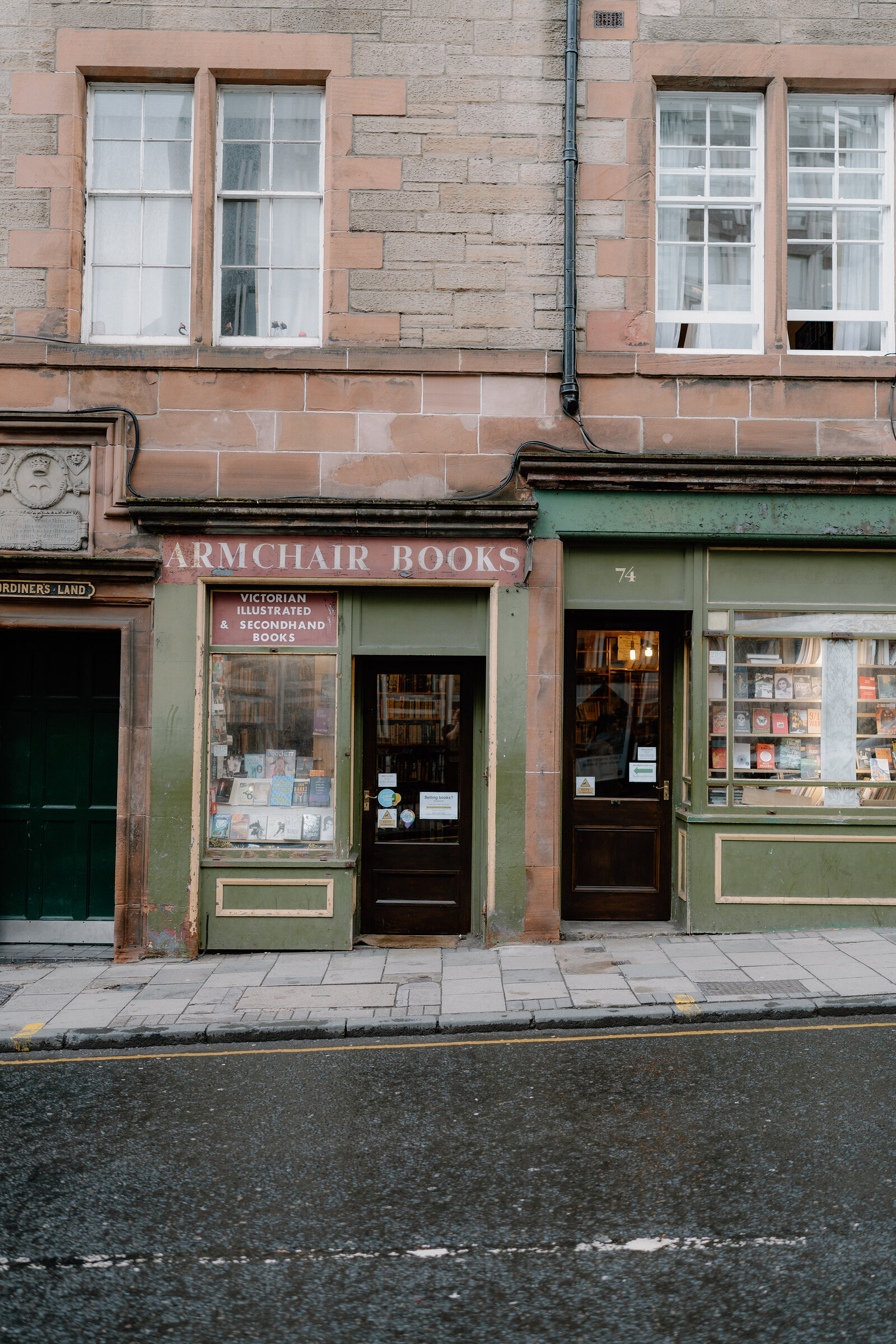 Armchair Books' sign advertises Victorian illustrated and secondhand books above its shopfront windows.