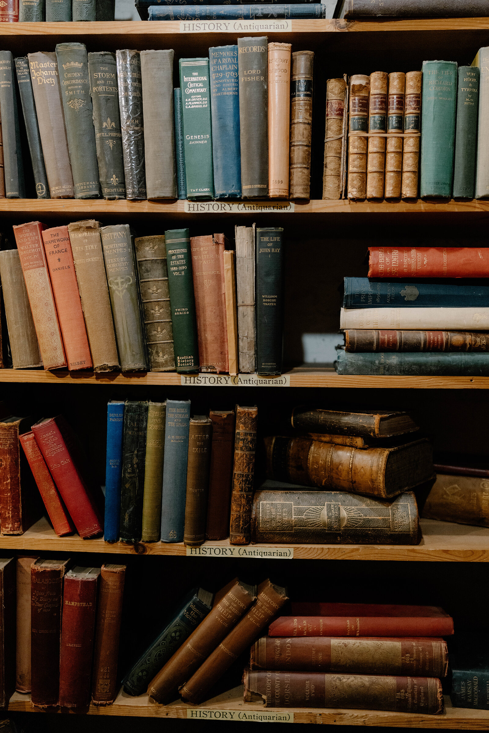 Antiquarian history shelves labelled "History (Antiquarian)", spines of varying age packed tightly together