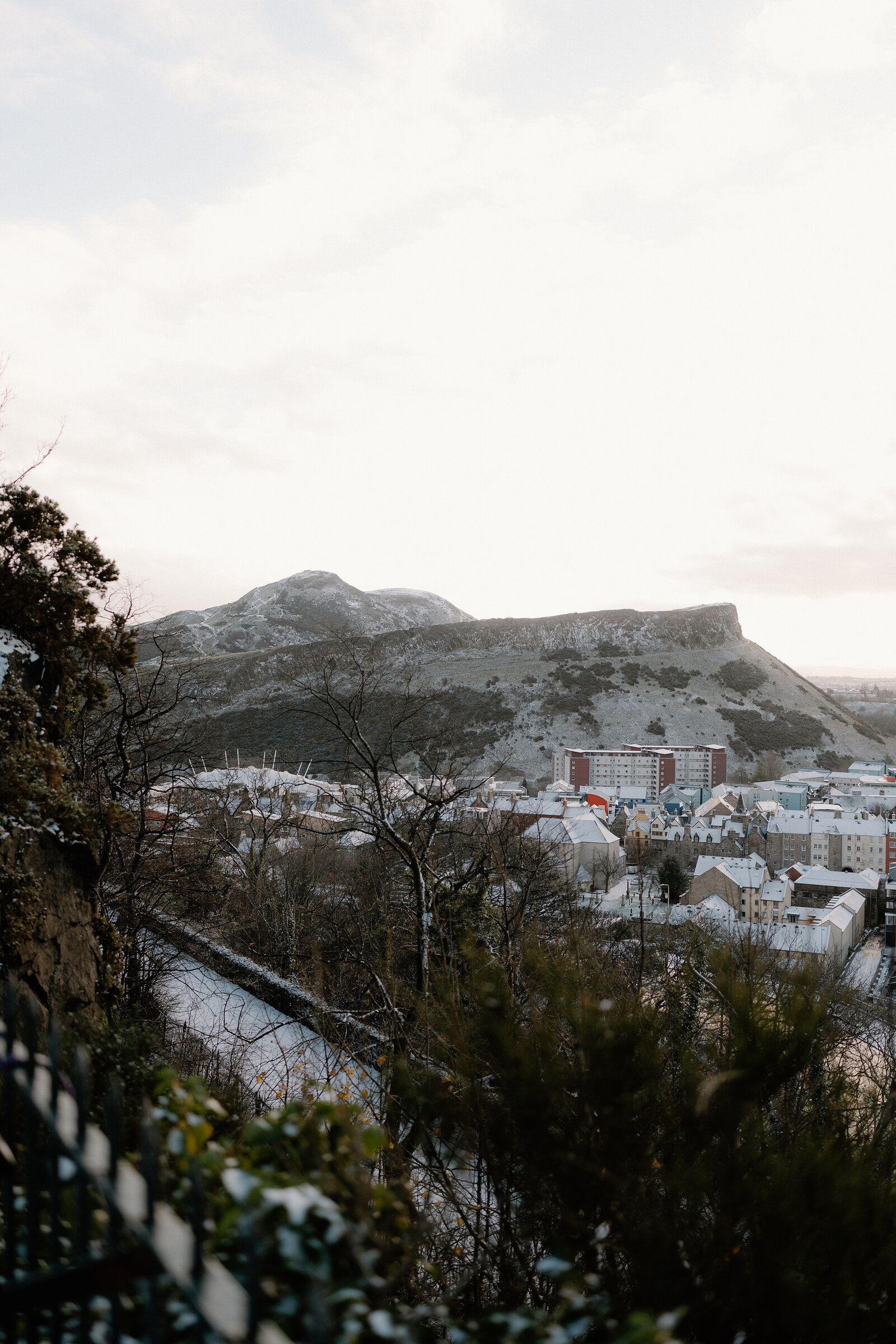 Snow dusts Arthur's Seat and Salisbury Crags above the rooftops of Edinburgh.