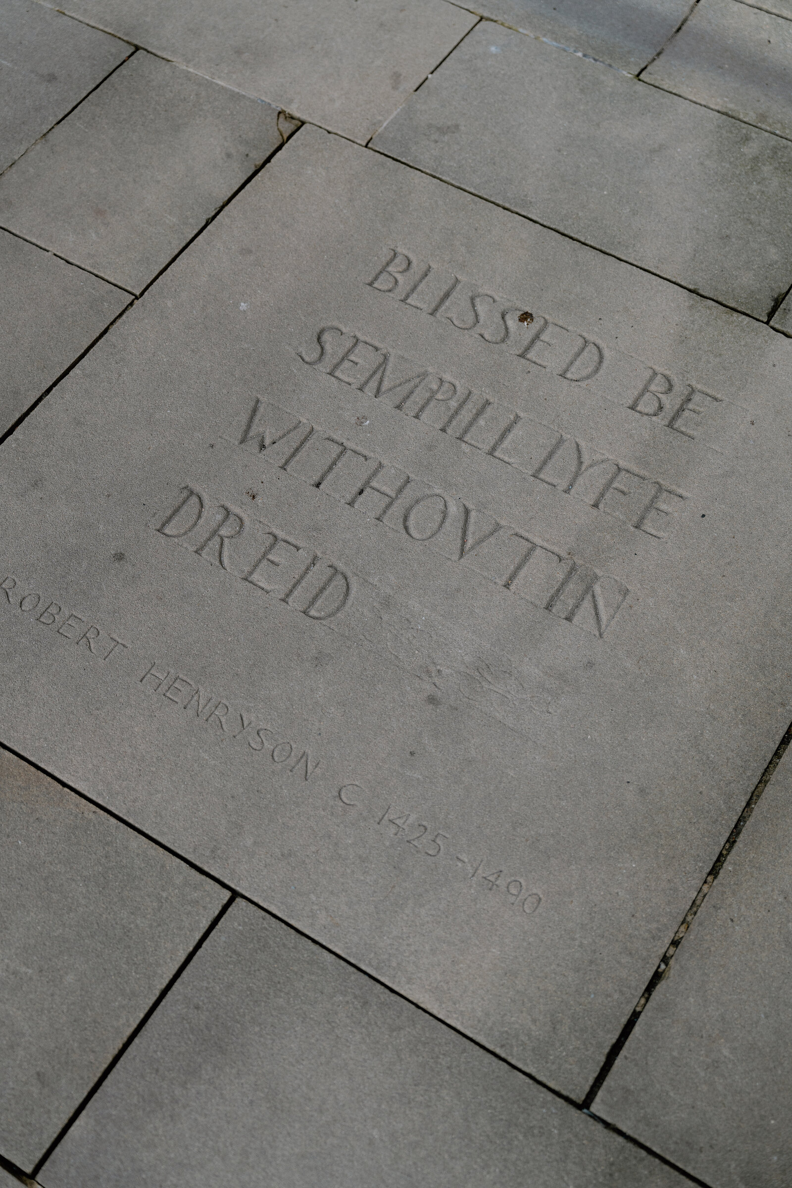 A paving stone at Makars' Court is inscribed with a verse by Robert Henryson.