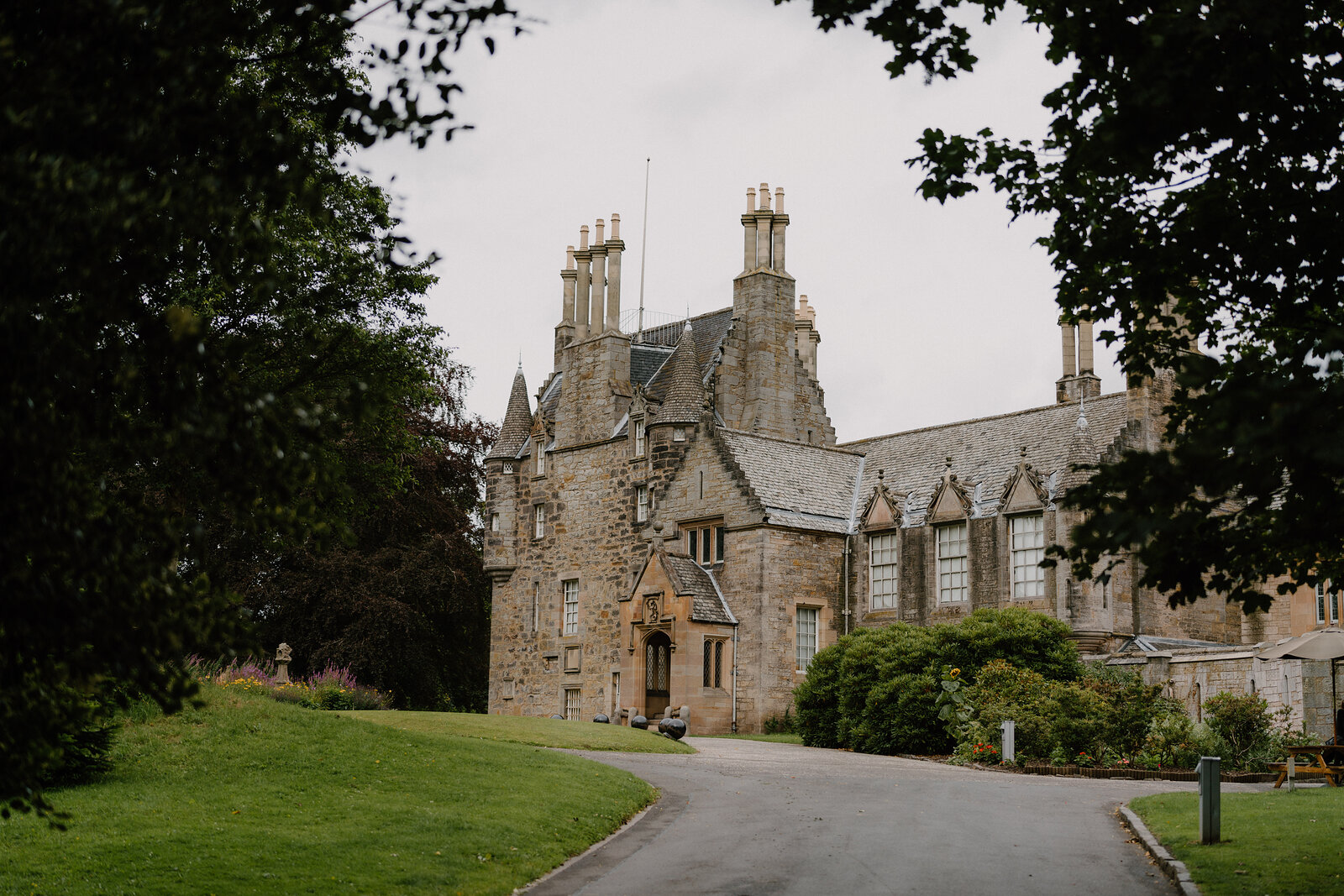 Lauriston Castle's Jacobean facade with clustered chimney stacks stands beyond a sweep of lawn.