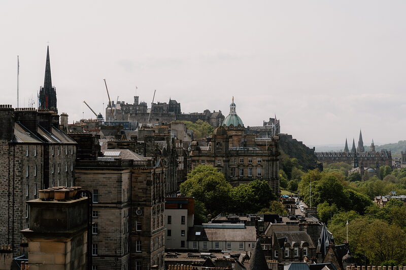 Edinburgh's Old Town skyline with the castle and a domed bank building rising above rooftops and spires.