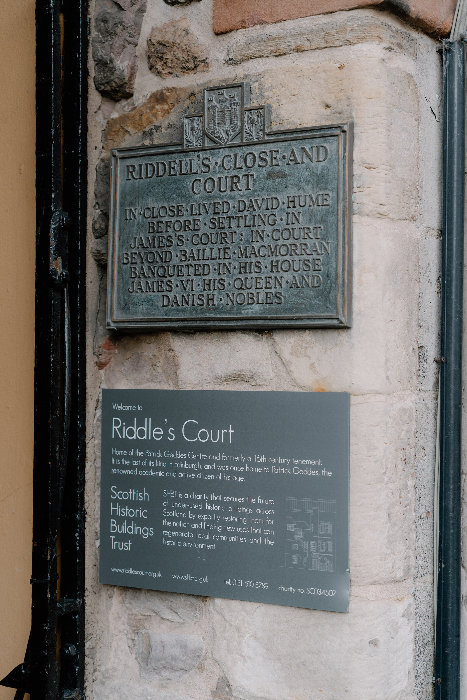 Weathered plaques at the entrance to Riddell's Close and Court, naming its historic residents