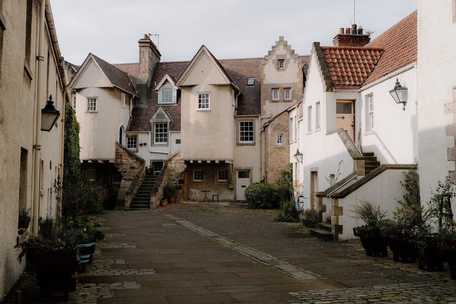 A quiet courtyard of white-harled, crow-stepped houses
