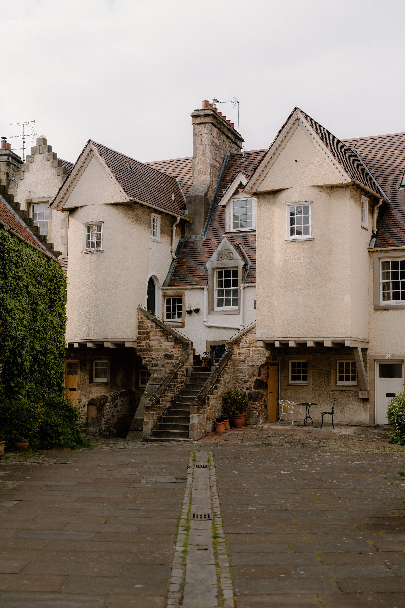 The stepped gables and outside stair of White Horse Close's white-harled houses