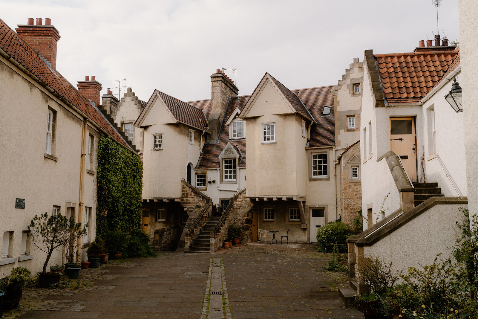 The stepped gables and outside stair of White Horse Close's white-harled houses
