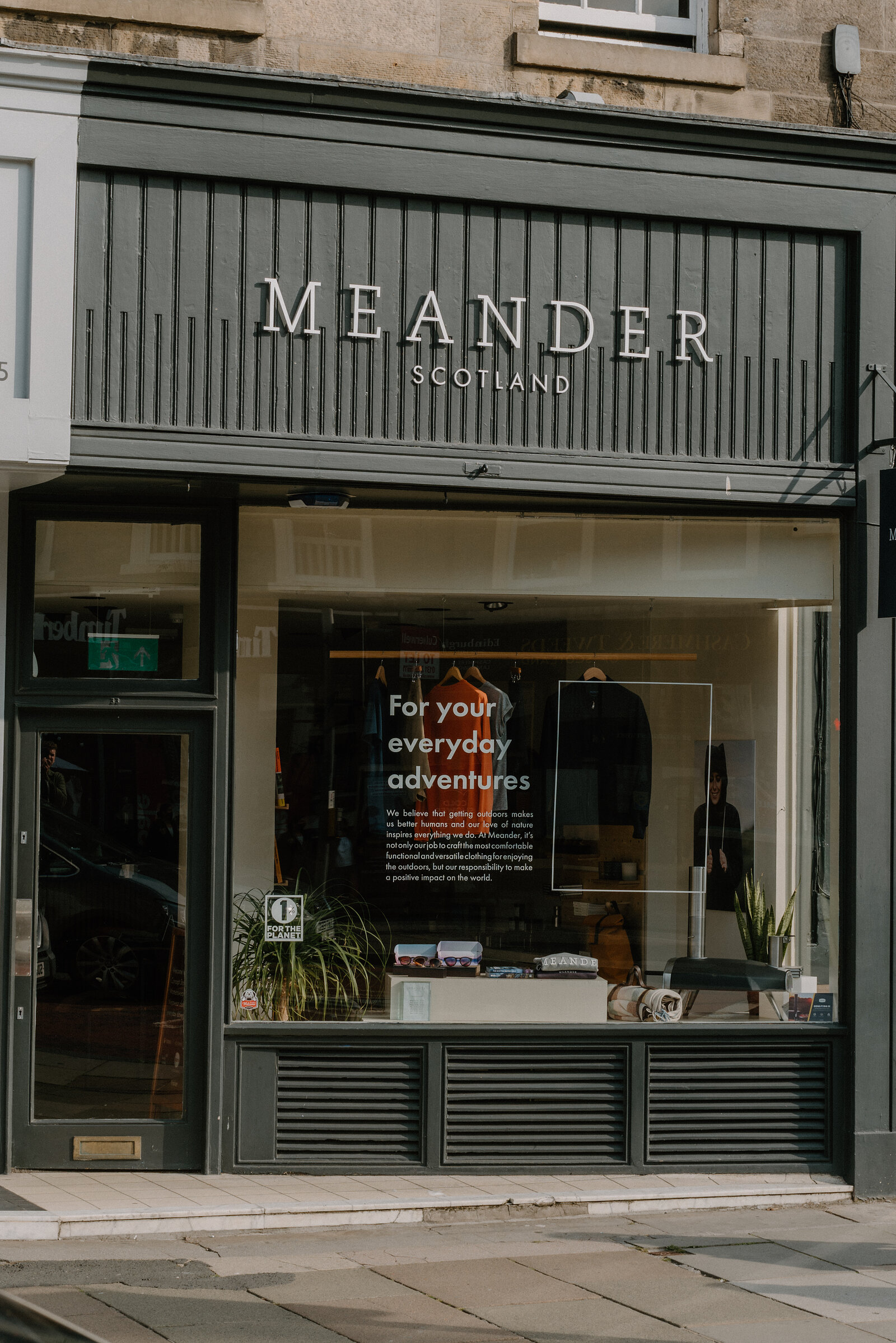 The olive-green shopfront of Meander Scotland, its window reading For Your Everyday Adventures
