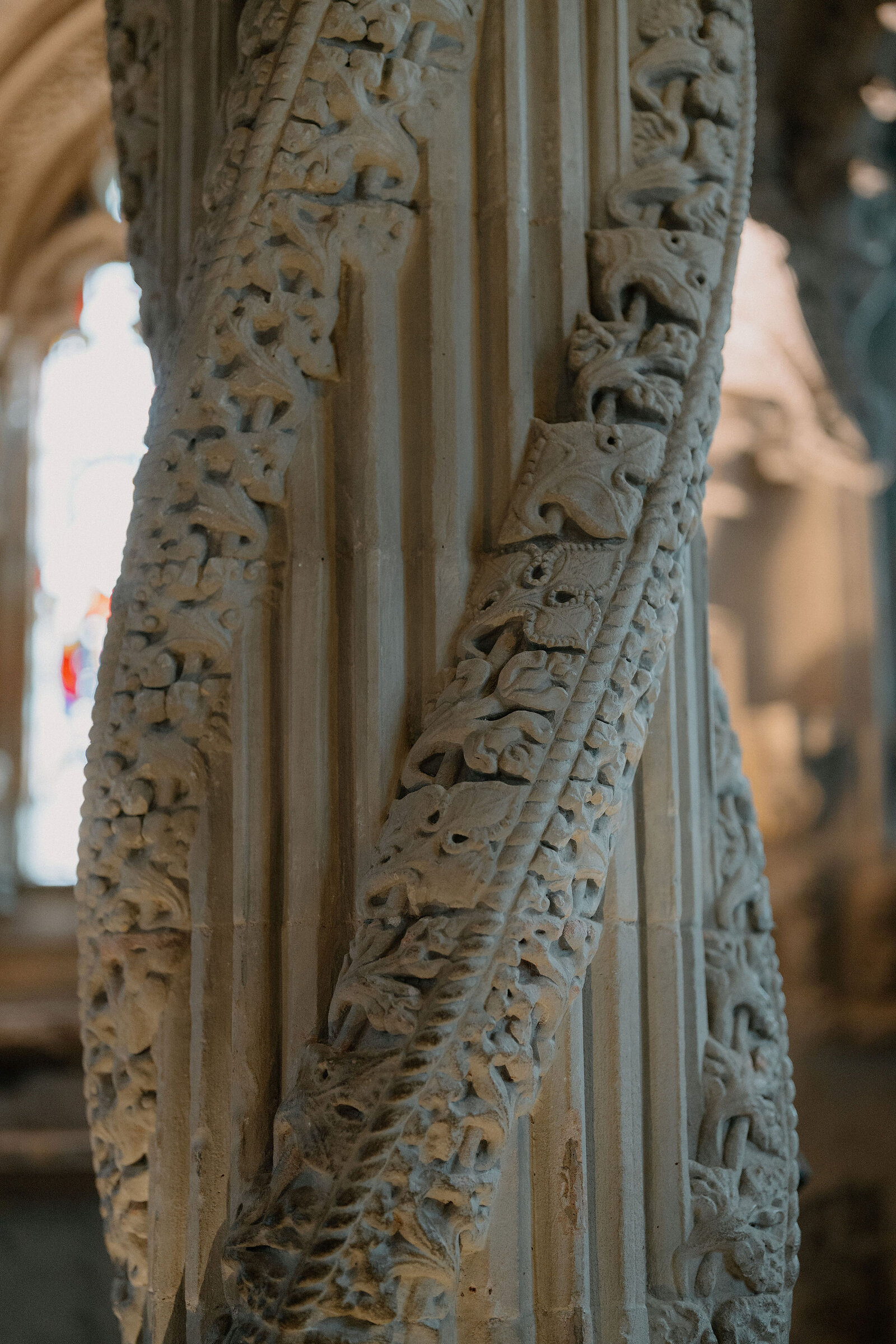 Rosslyn Chapel's carved Apprentice Pillar spirals with intricate stonework, seen up close.