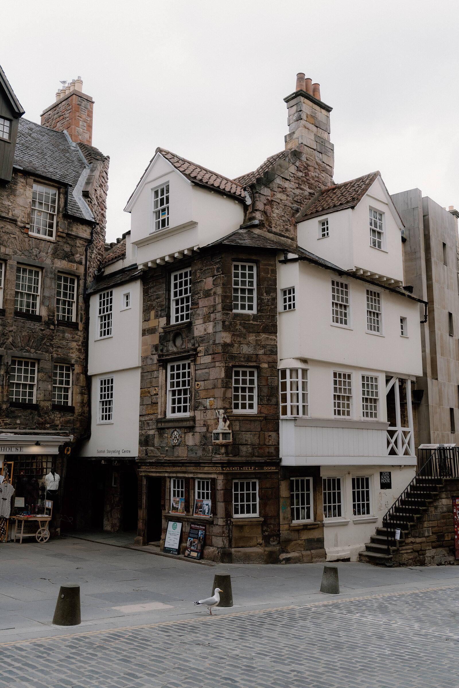 The Scottish Storytelling Centre's timber-fronted building on the Royal Mile, its white harled upper floor set above a stone ground floor with crow-stepped gables.