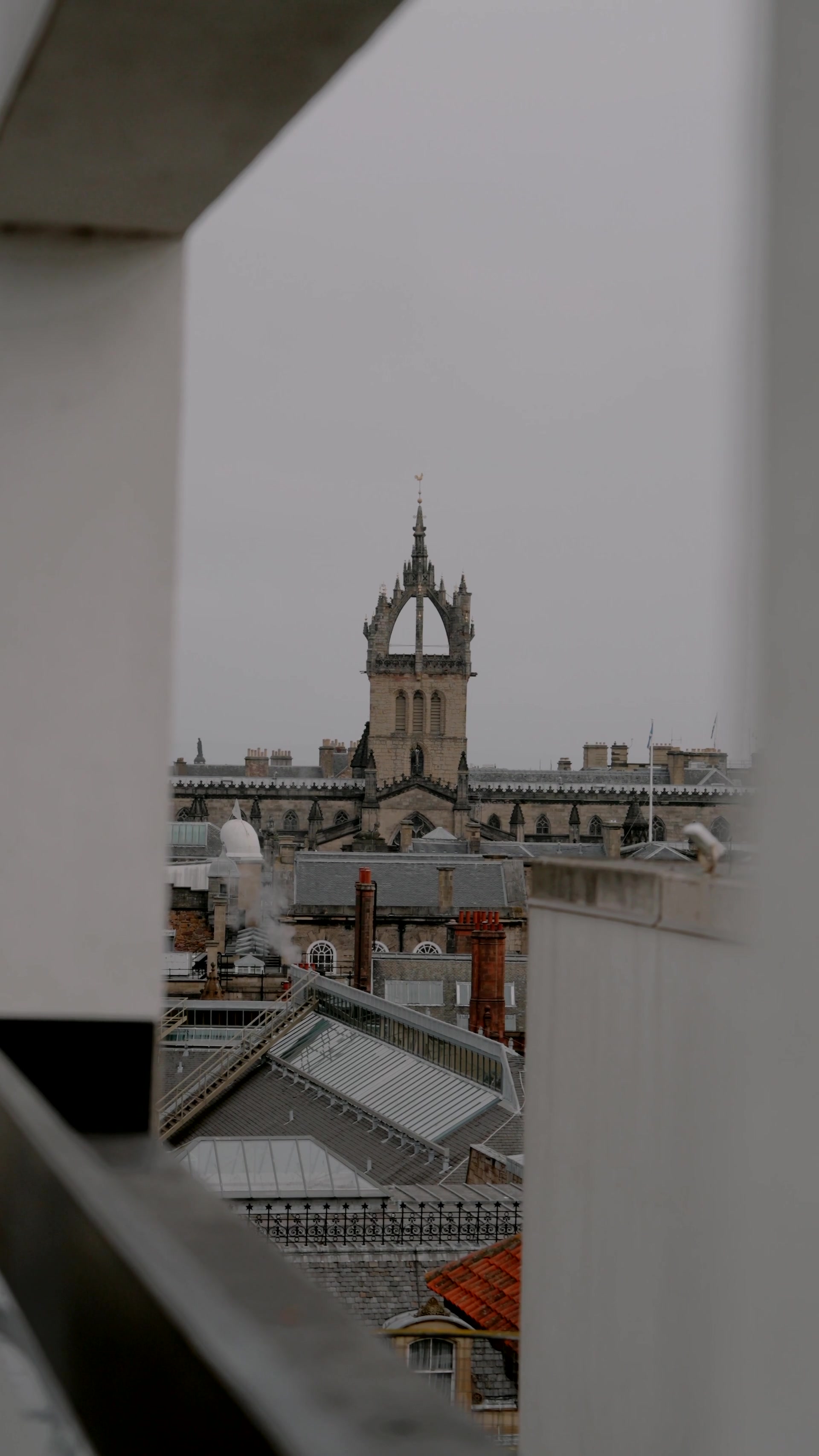 a Gothic spire rises above Old Town rooftops and chimney pots