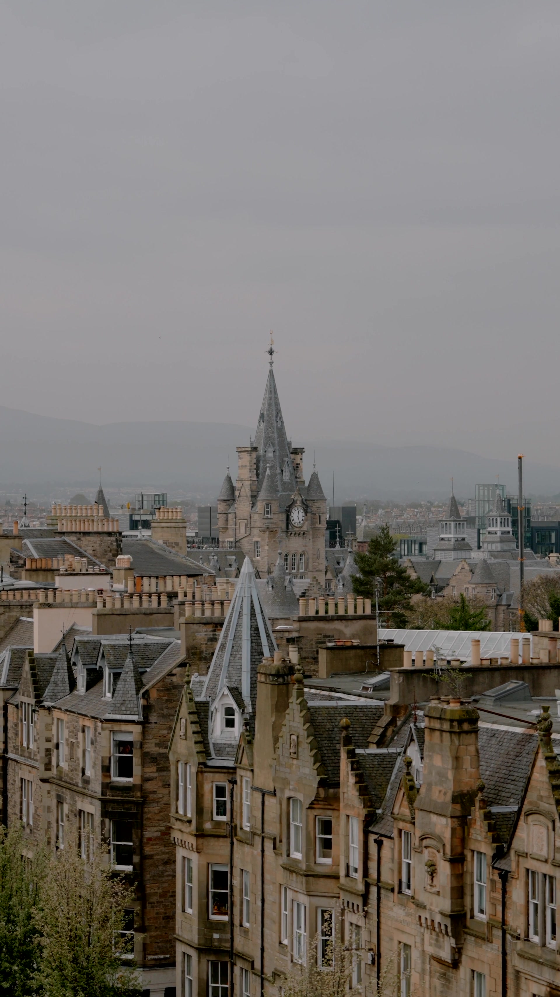 a Gothic clock tower rises above Old Town rooftops and chimney pots