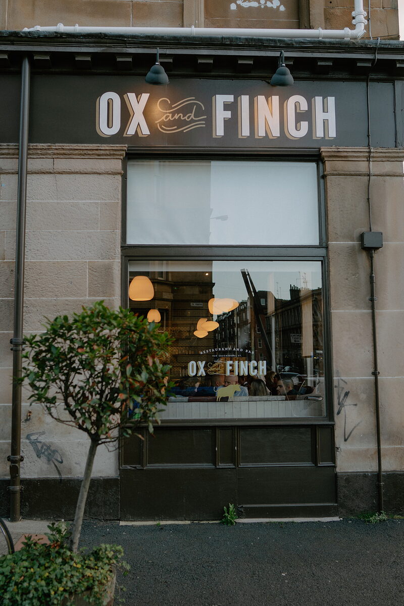 Ox and Finch's dark front with its name over the window.