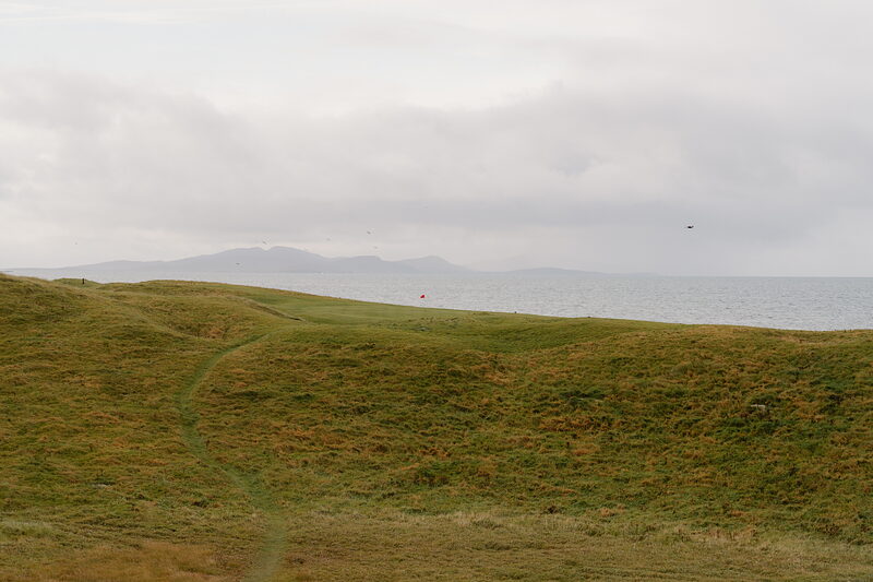 A grassy path winds through dunes overlooking the sea at Askernish.