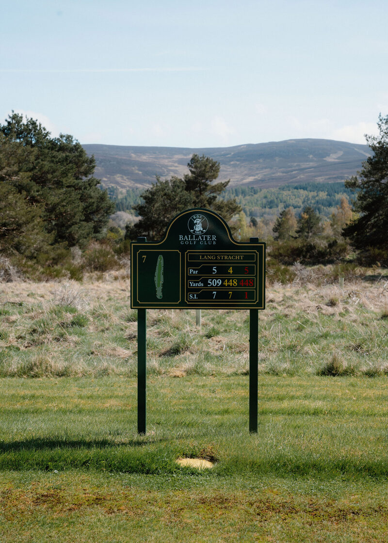 The 7th tee sign at Ballater Golf Club, Lang Stracht, 509 yards from the white tees, with heather hills behind.