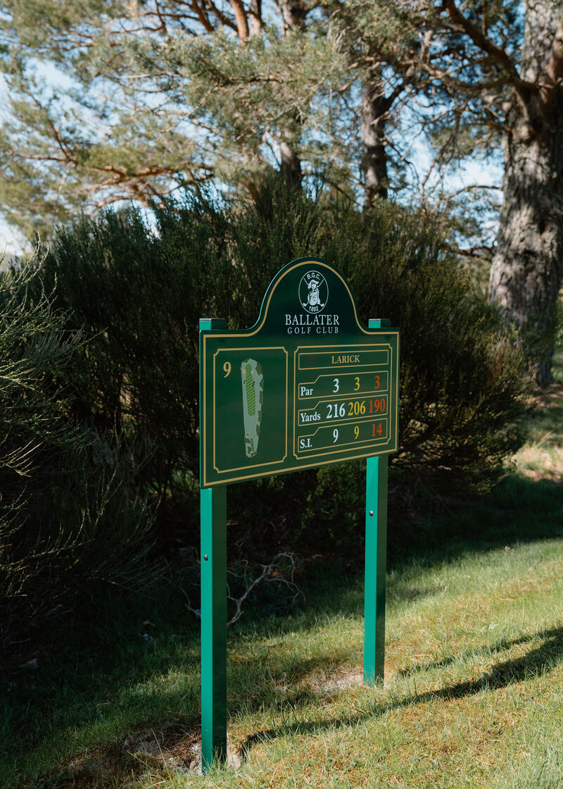The 9th tee sign at Ballater Golf Club, Larick, par 3, 216 yards, set among broom.