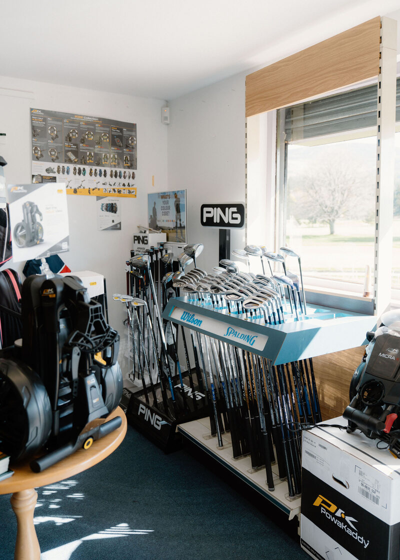 Golf clubs, bags and trolleys on display inside the professional’s shop.