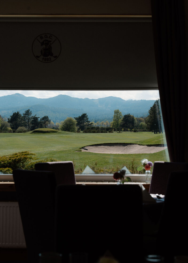 A greenside bunker and hills seen from the clubhouse restaurant window.