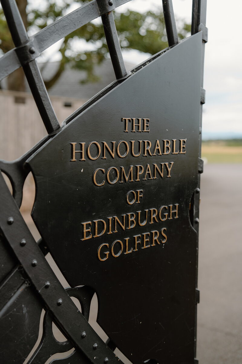 A wrought-iron gate reading The Honourable Company of Edinburgh Golfers