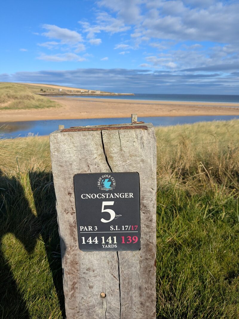 The 5th tee post at Reay, Cnocstanger, par 3, 144 yards, with the beach and a burn behind.