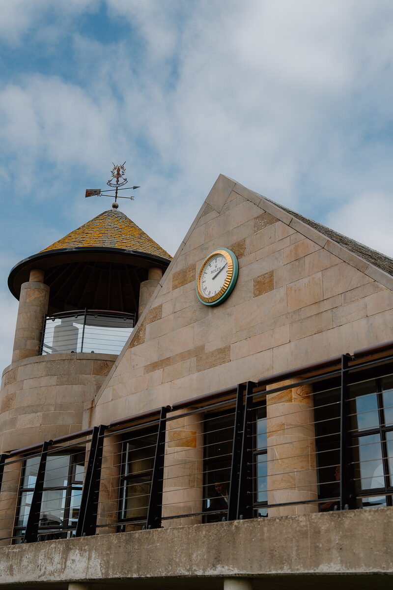 Golfers gathered on a green at St Andrews Links, their bags set beside them.