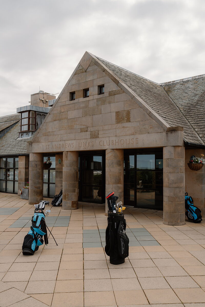 St Andrews Links Clubhouse's own carved lettering above its stone entrance, golf bags resting on the terrace.