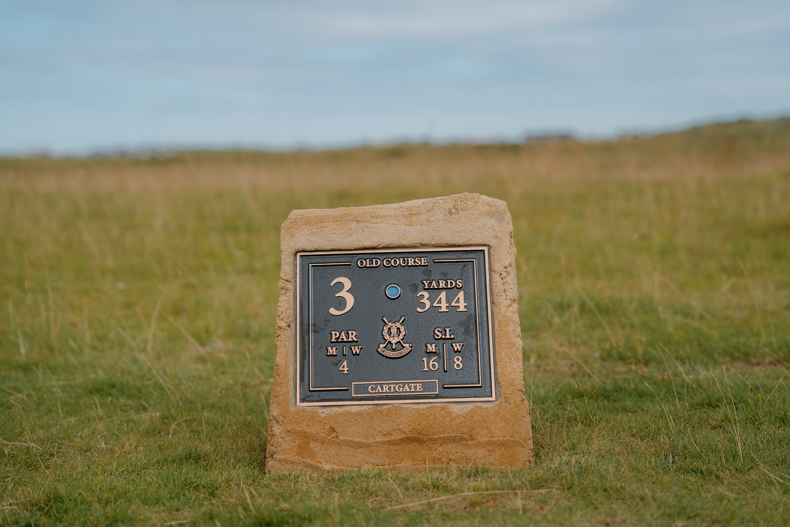 A stone plaque for the Old Course's Cartgate hole gives its par and yardage.