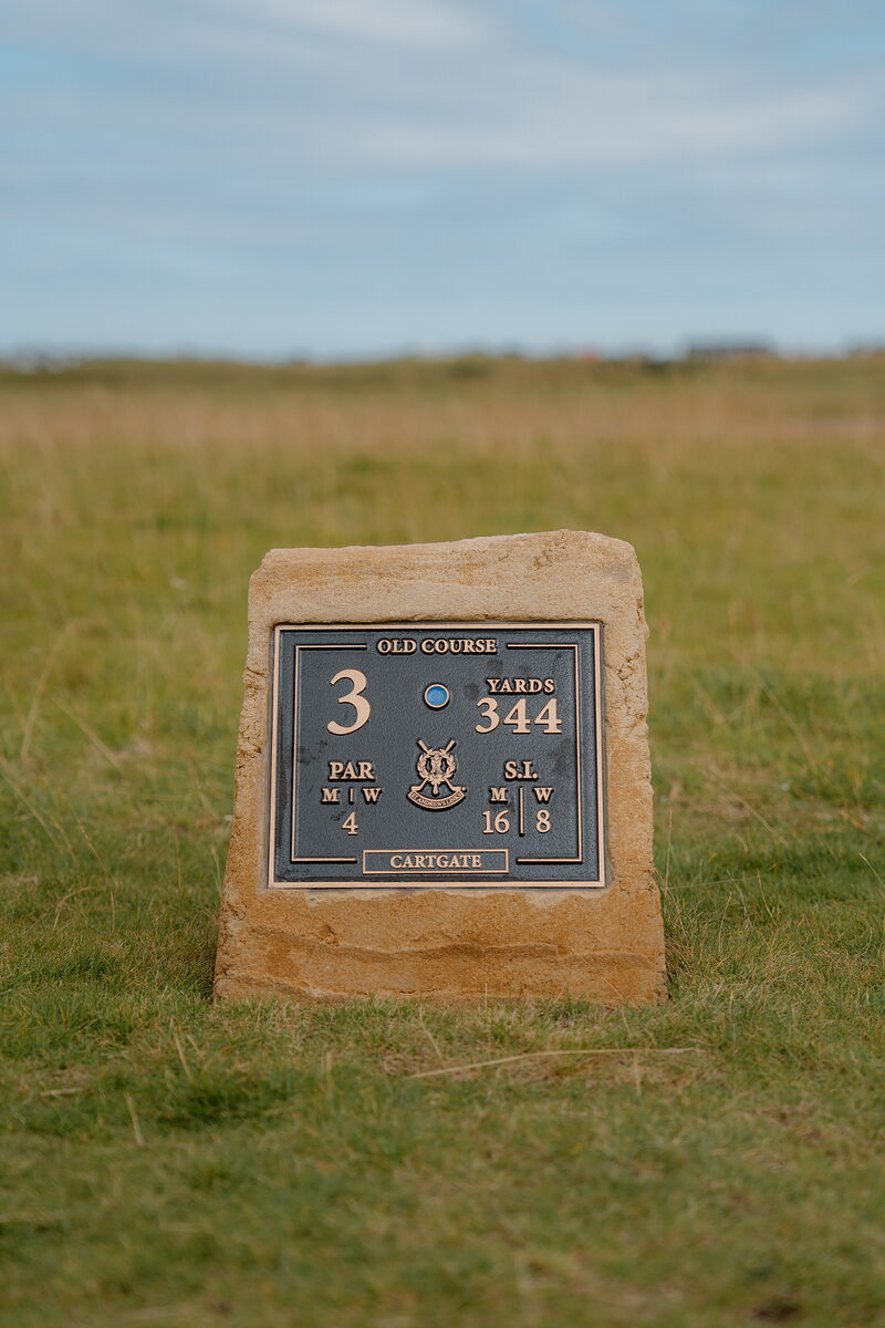 A stone plaque for the Old Course's Cartgate hole gives its par and yardage.