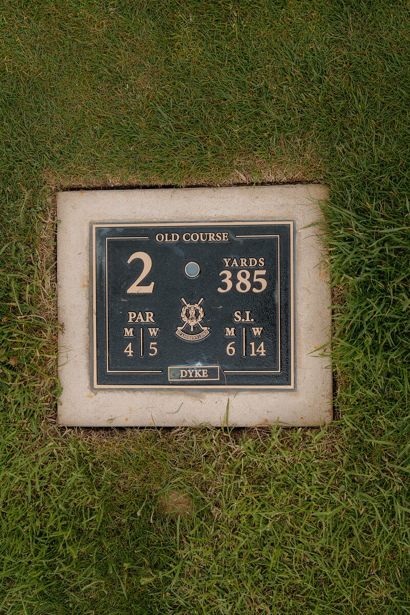A stone plaque for the Old Course's Dyke hole gives its par and yardage.