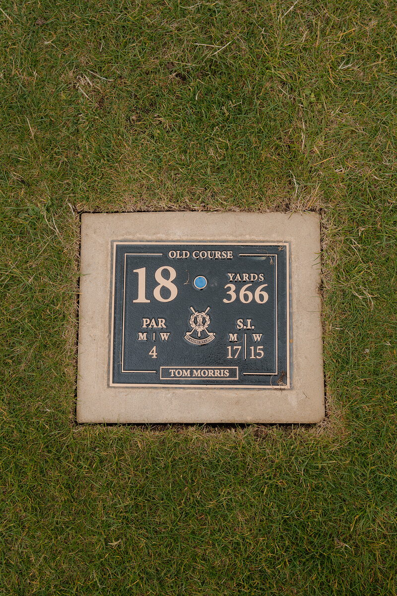 A stone plaque names the Old Course's Tom Morris hole, giving its par and yardage.