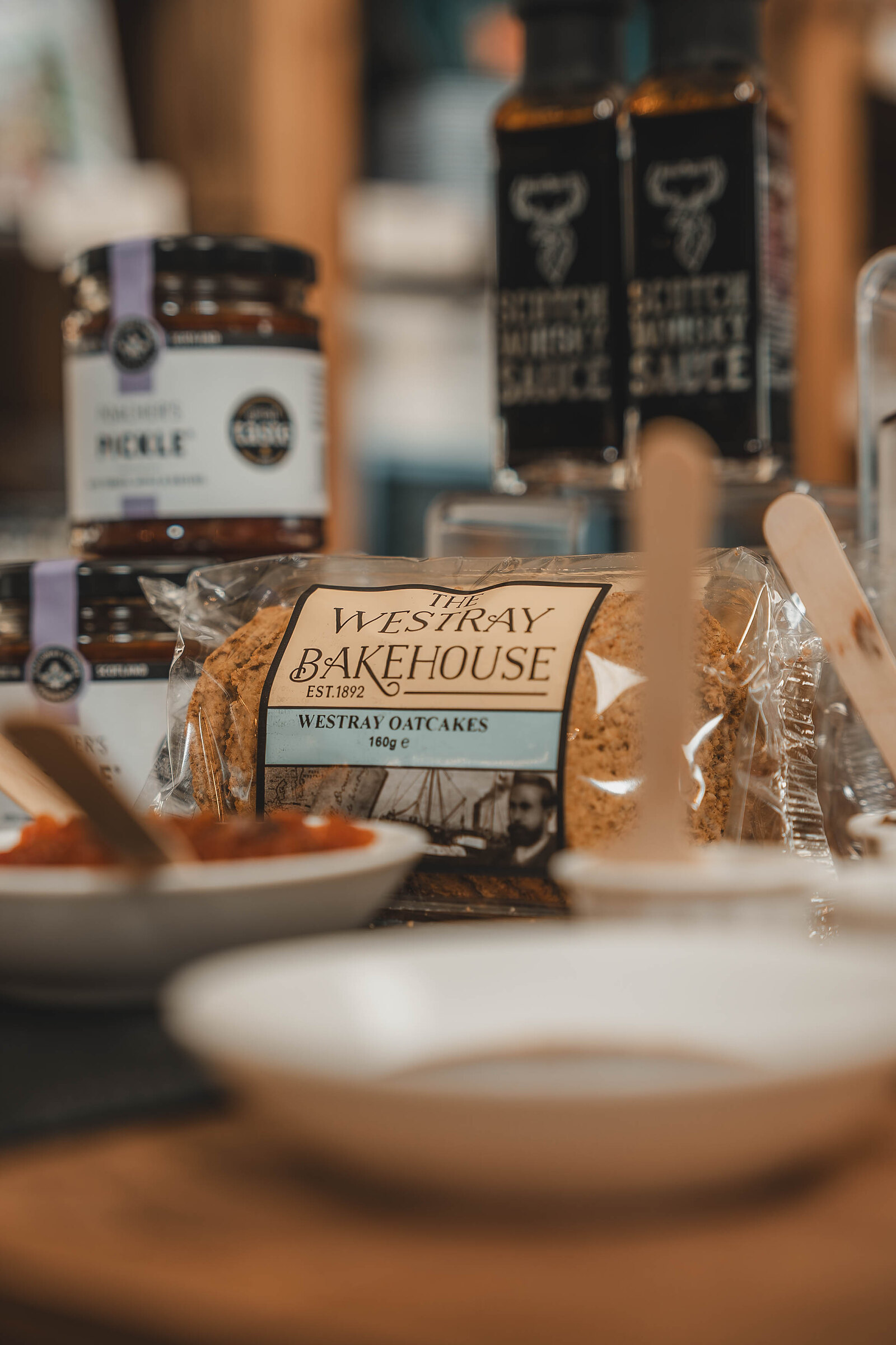 Jars of pickle and sauce and a packet of Westray Bakehouse oatcakes laid out for tasting.