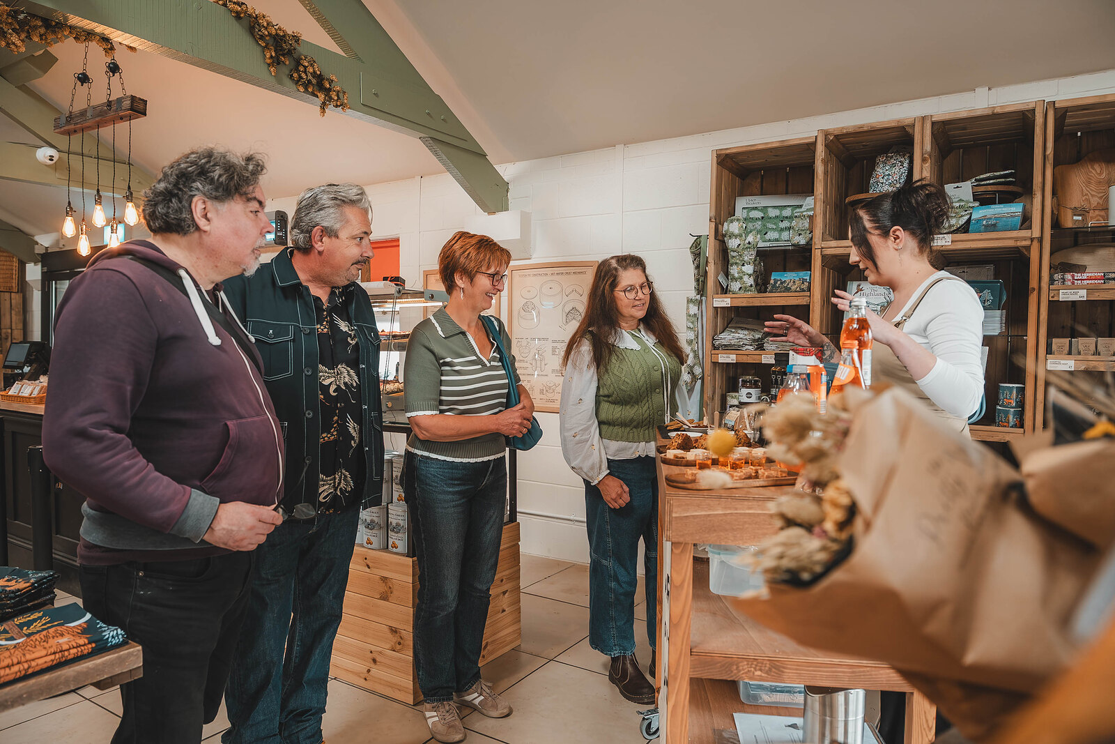 A small group gathers at the tasting counter in the Gretna Green larder.