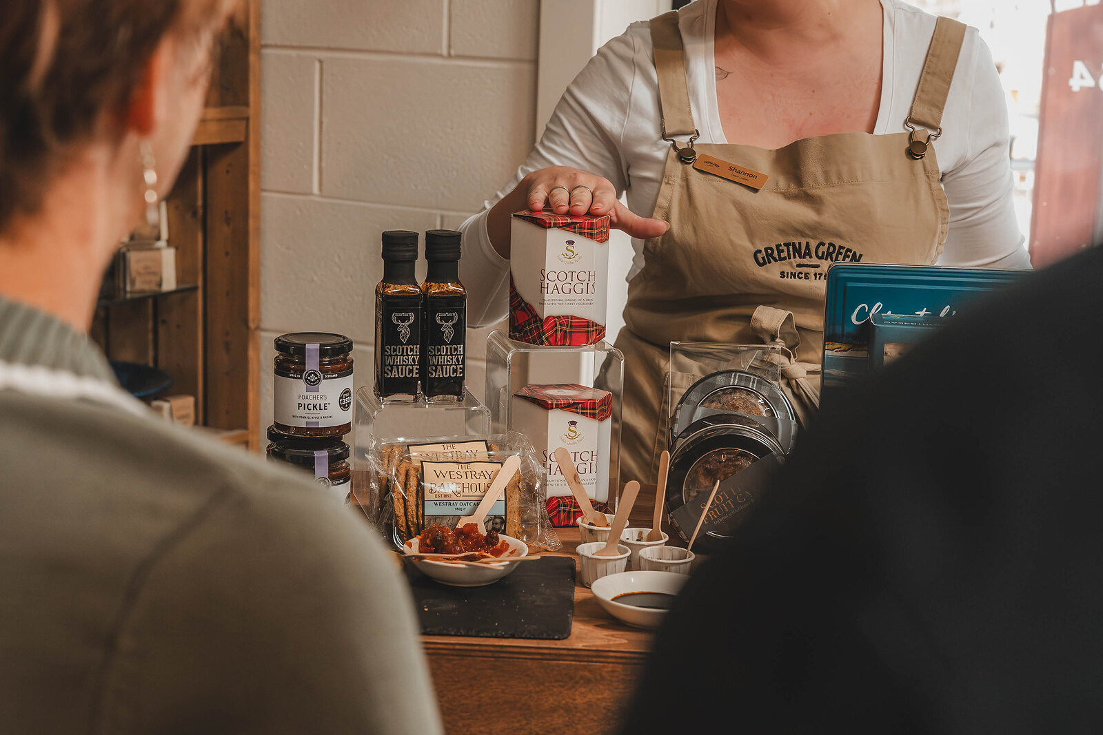 A host sets out jars, sauces and treats for the tasting.