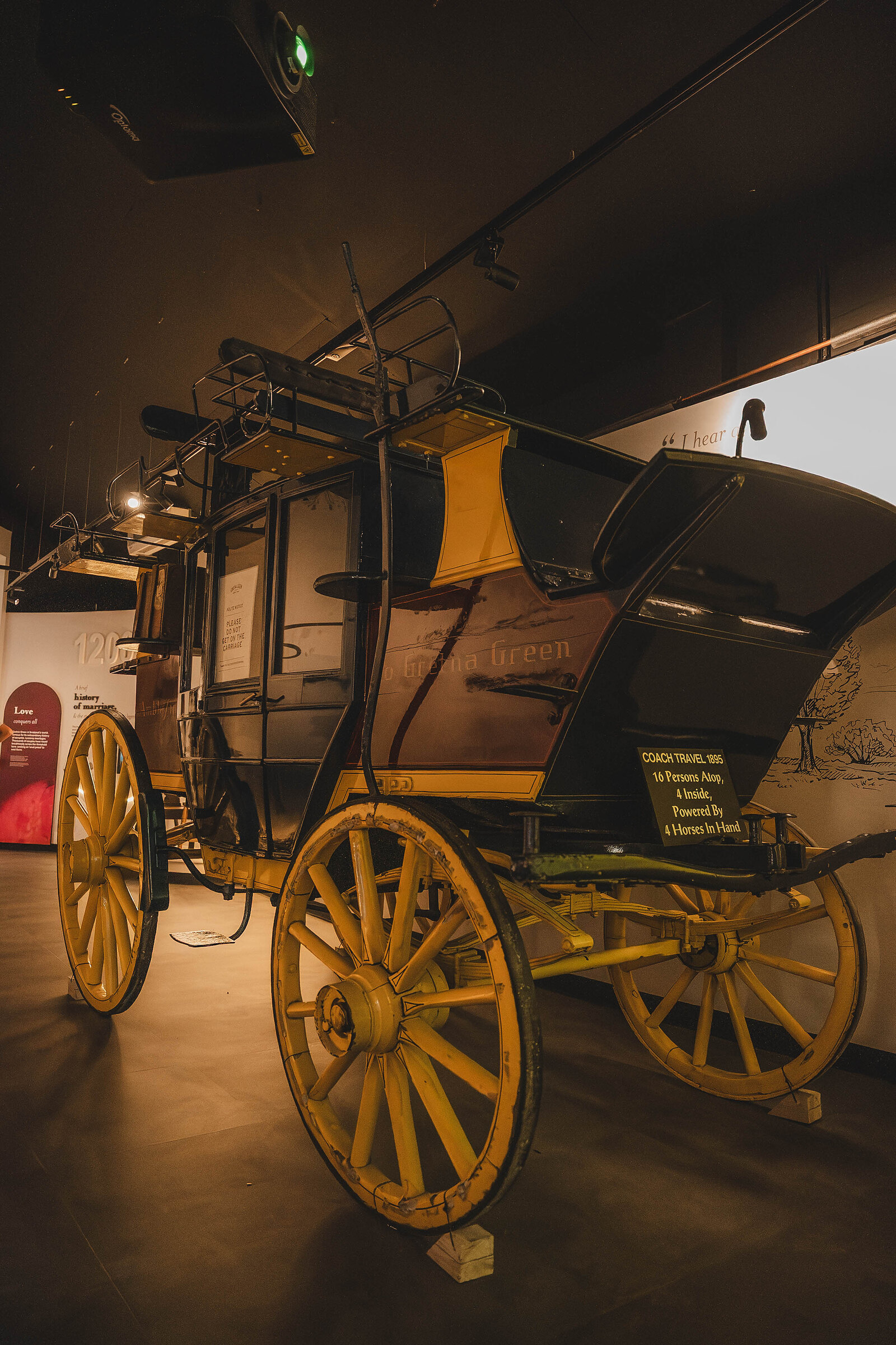 An old yellow-wheeled carriage in the Famous Blacksmiths Shop museum.