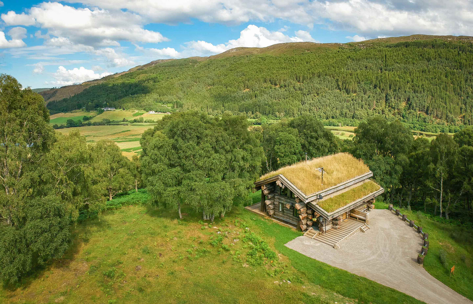 From above, Certhia on its green ridge, the glen, fields and forested hills of Strathglass beyond.