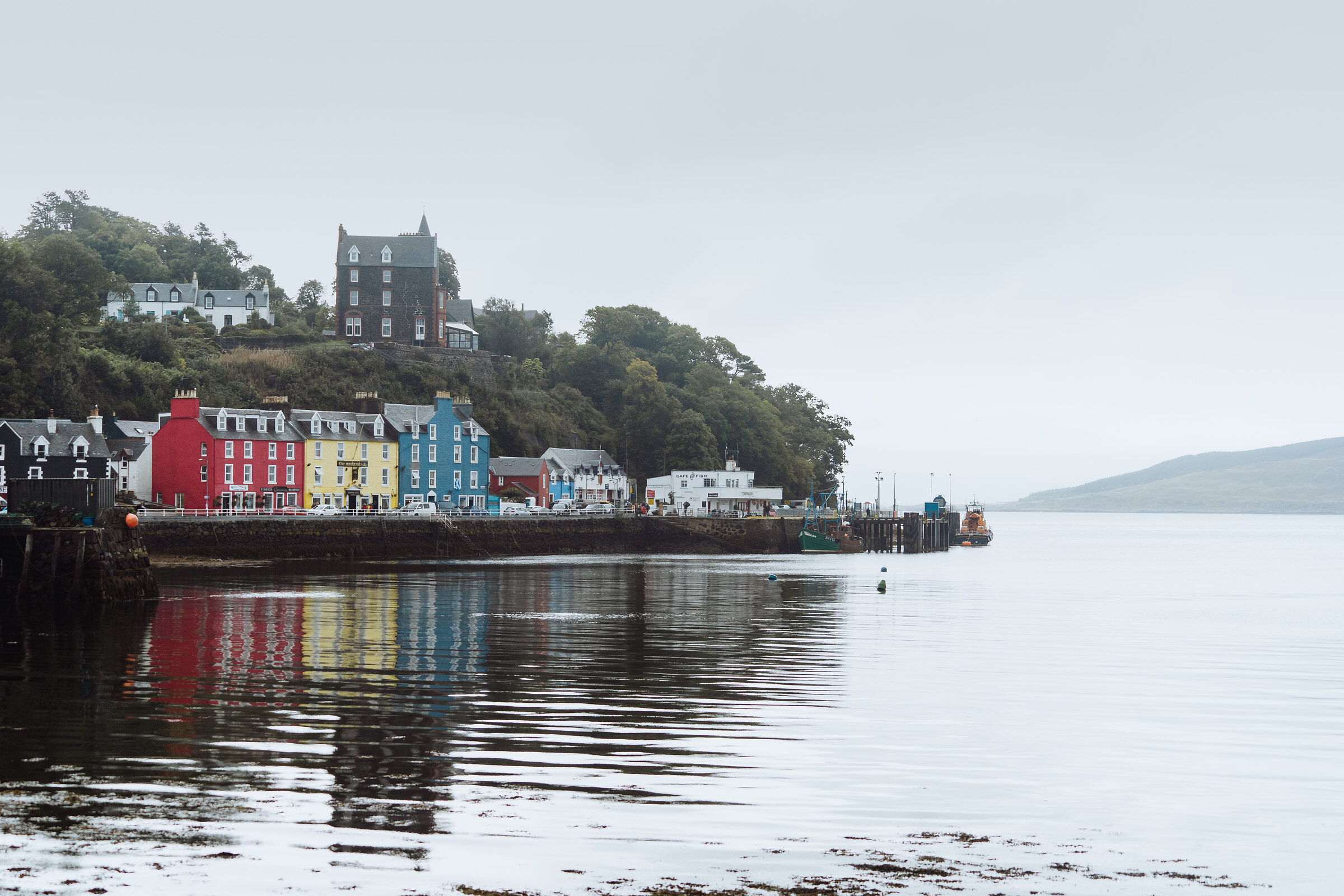 Tobermory's painted harbour front at low tide.