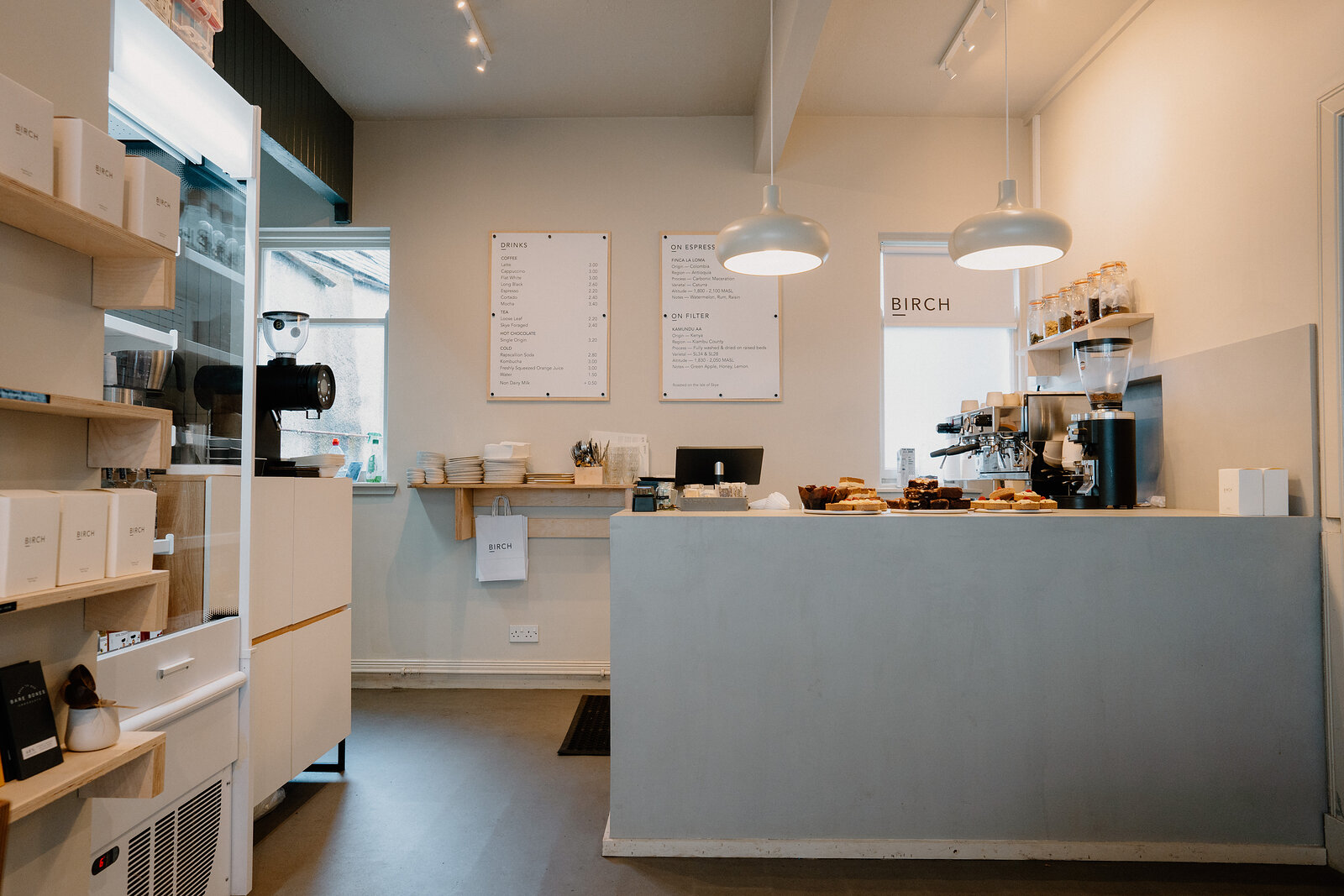 Birch's counter holds baked goods beside its till and espresso machine.