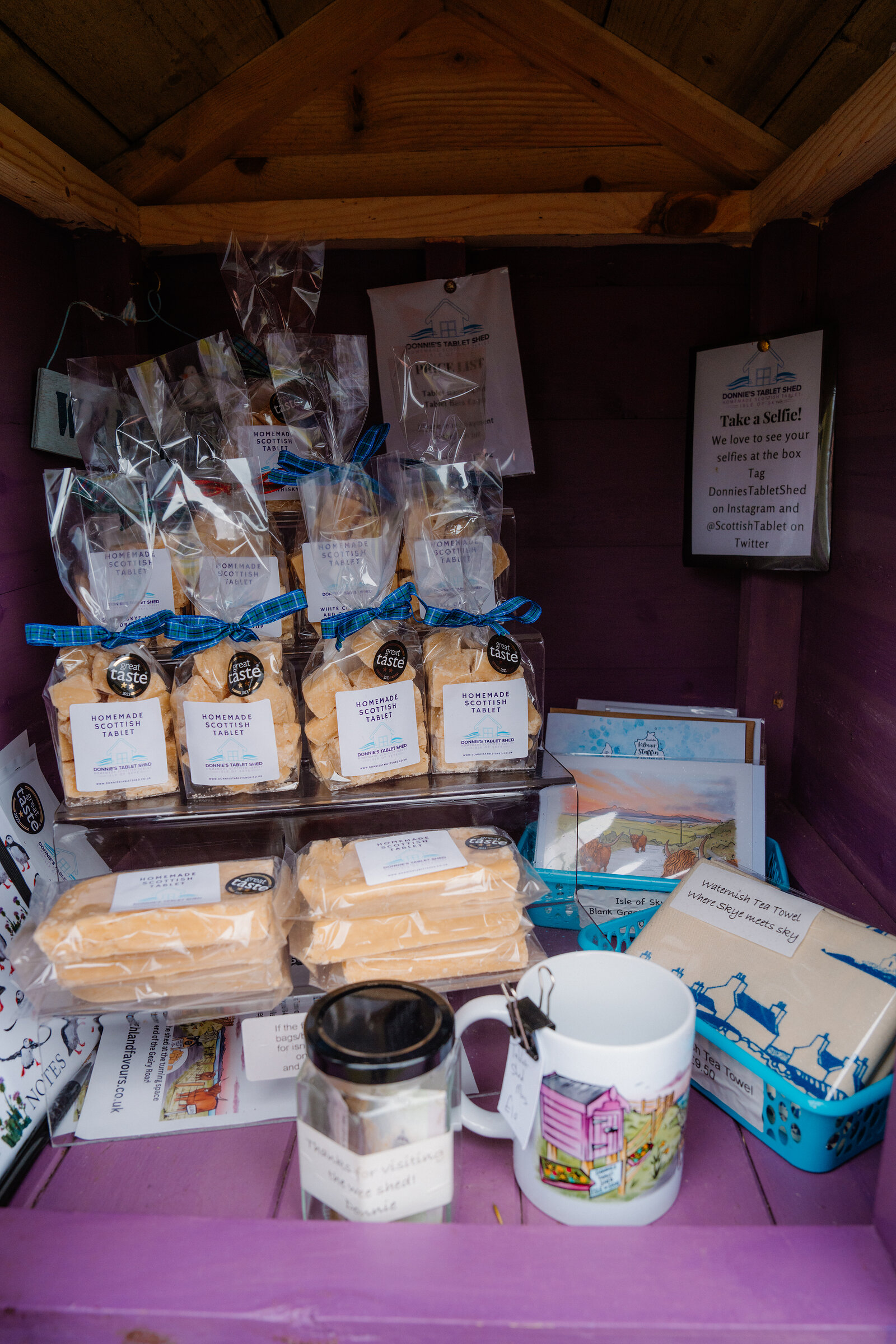 Packets of homemade Scottish tablet tied with tartan ribbon fill the shelves of Donnie's Tablet Shed.