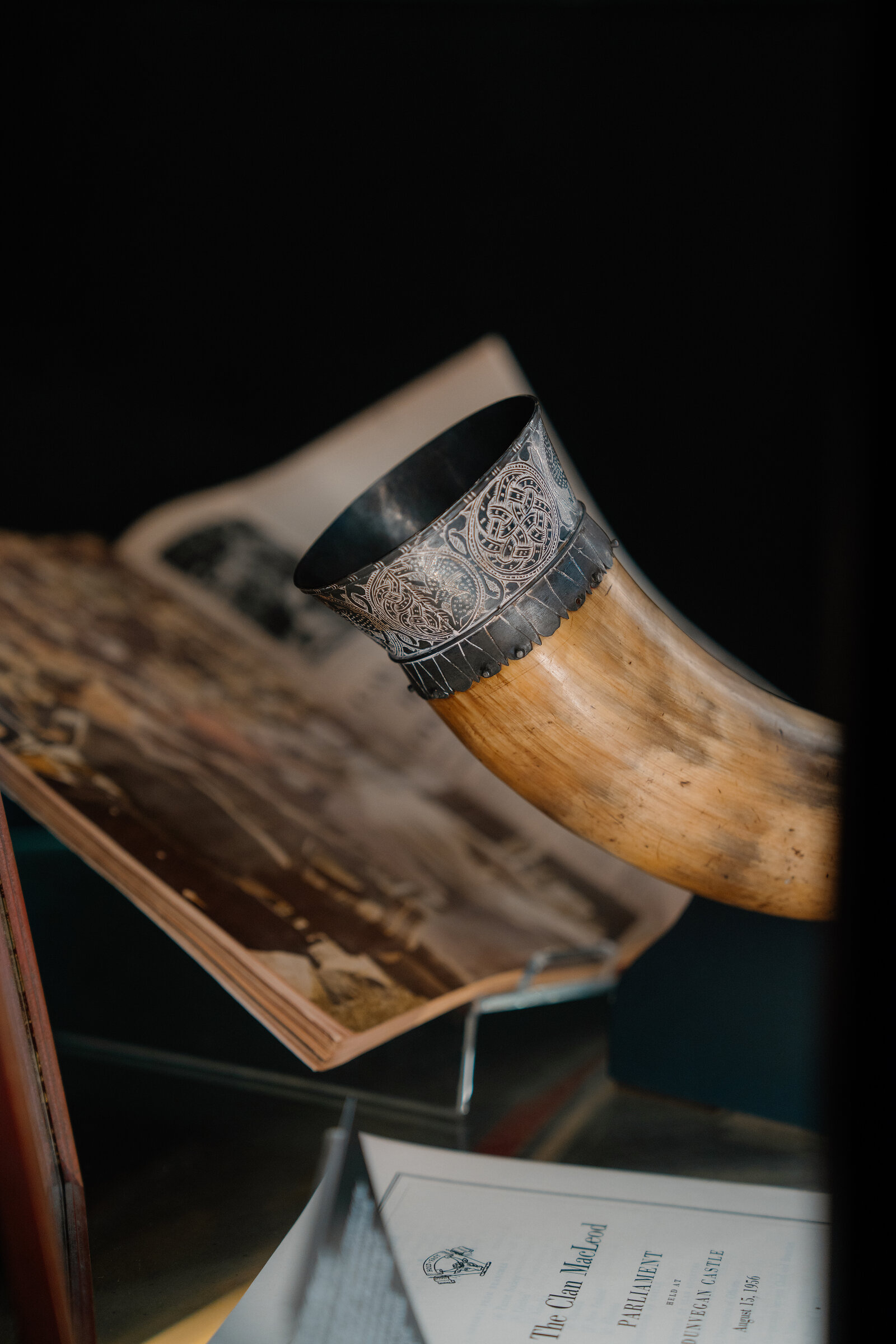 Rory Mor's Horn, mounted in silver, is displayed beside an open photograph album at Dunvegan Castle.
