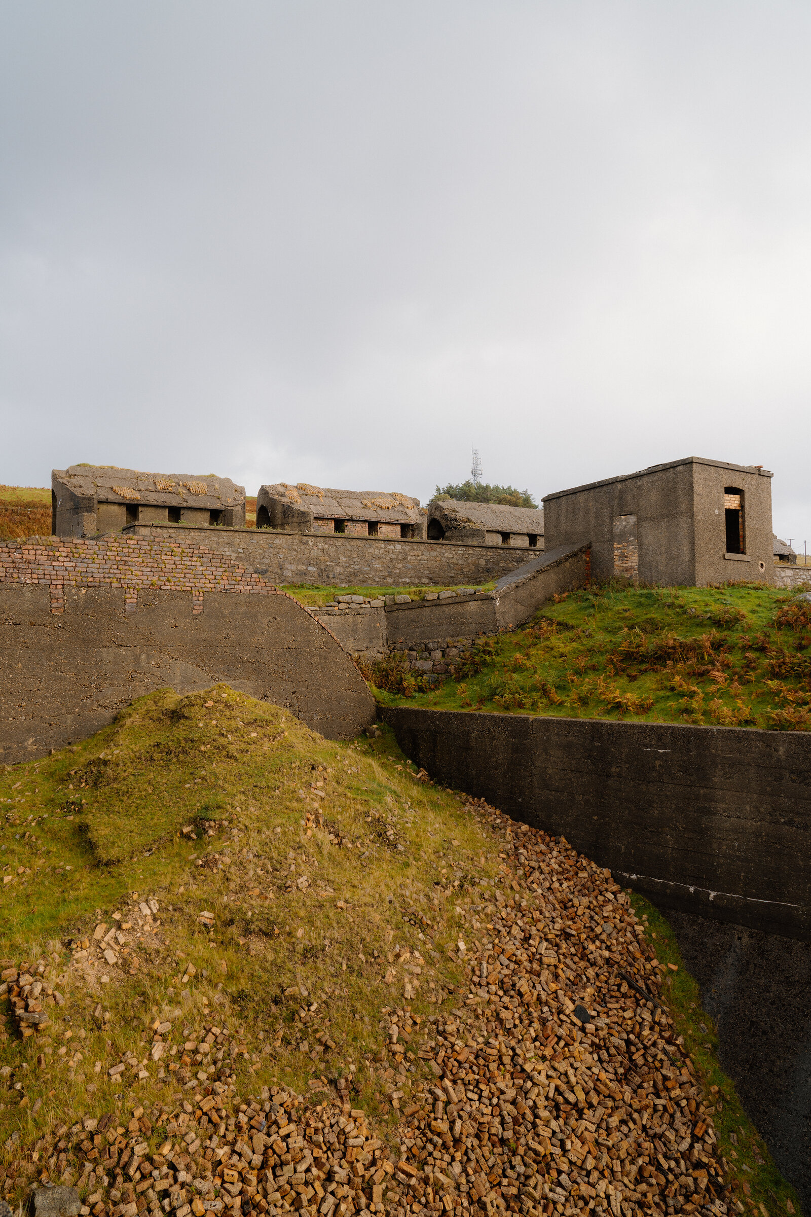 Concrete kiln ruins line a grassy hillside on the Isle of Skye.
