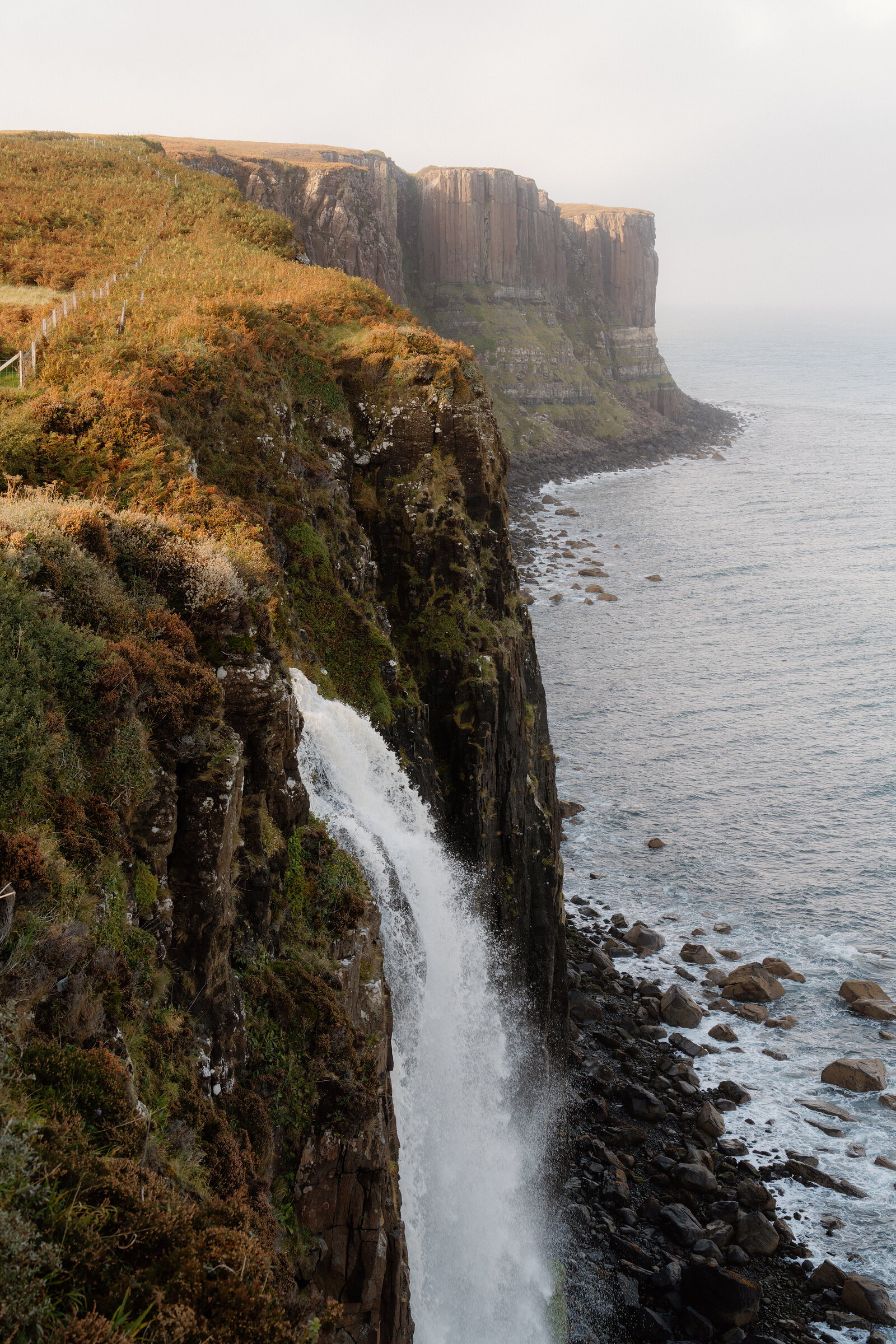 Kilt Rock's layered basalt cliffs drop to the sea beside Mealt Falls on the Isle of Skye.