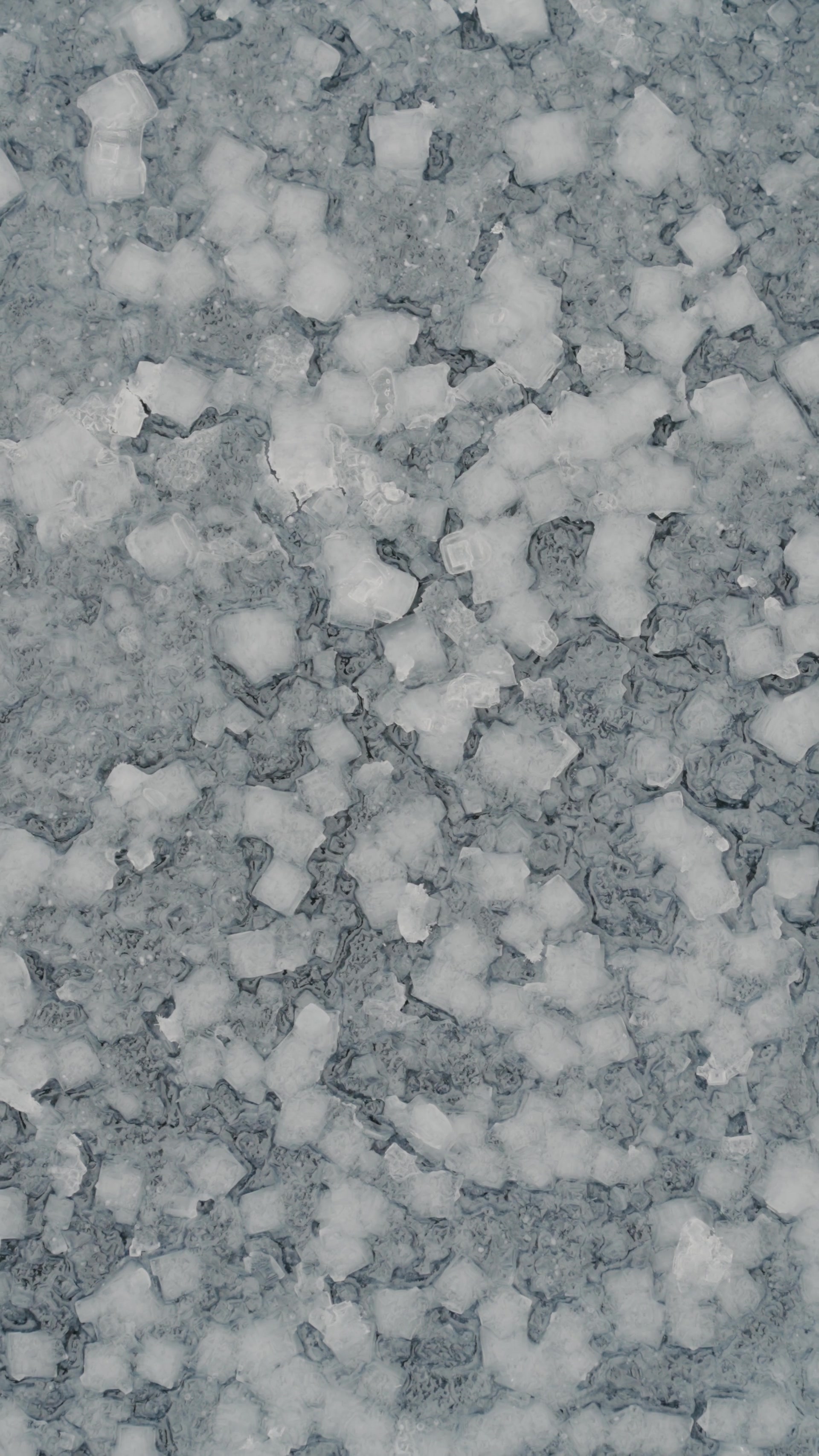 A close view shows jagged ice crystals coating a frosted surface.
