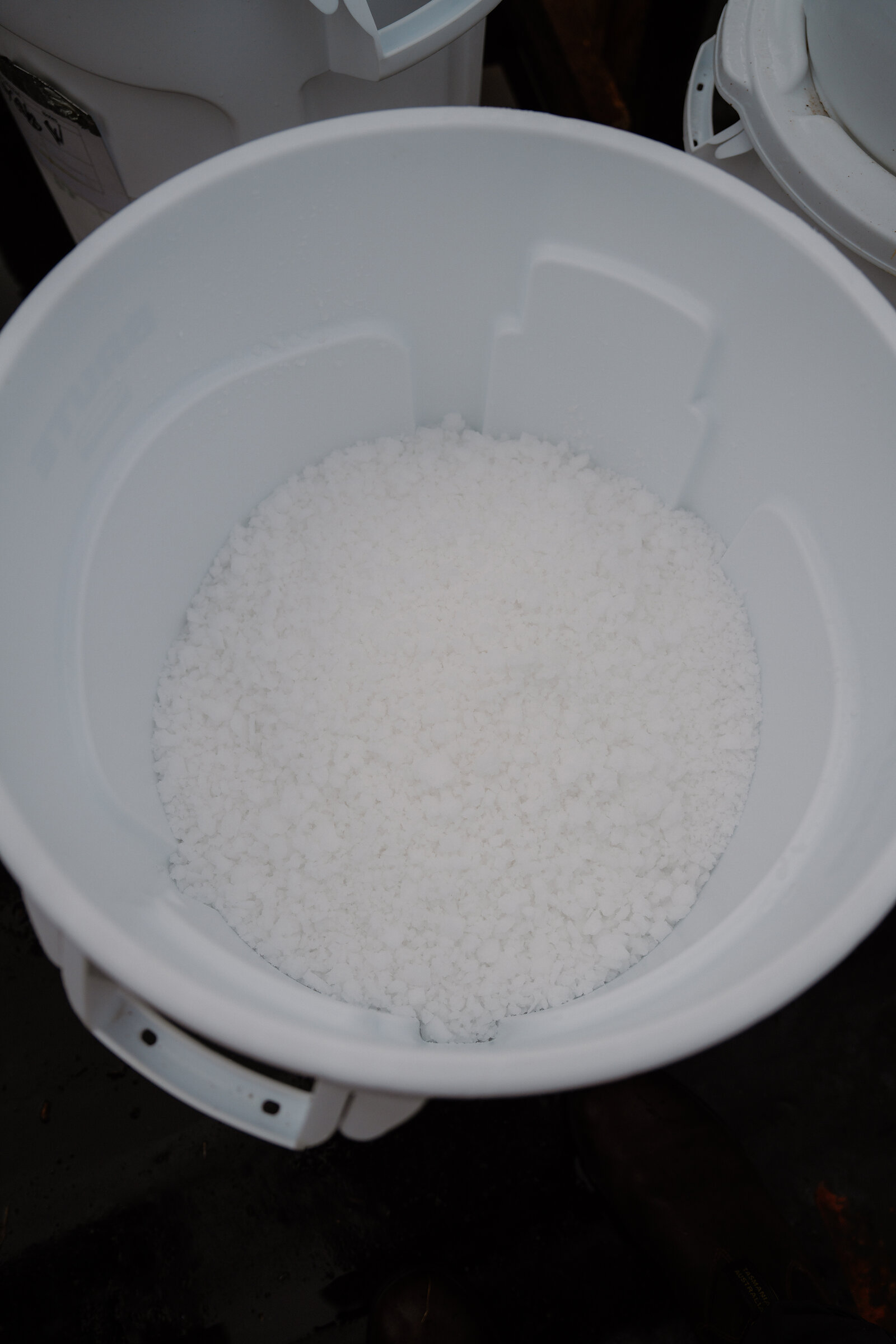 A white bucket holds a mound of harvested sea salt crystals at Isle of Skye Sea Salt Company.